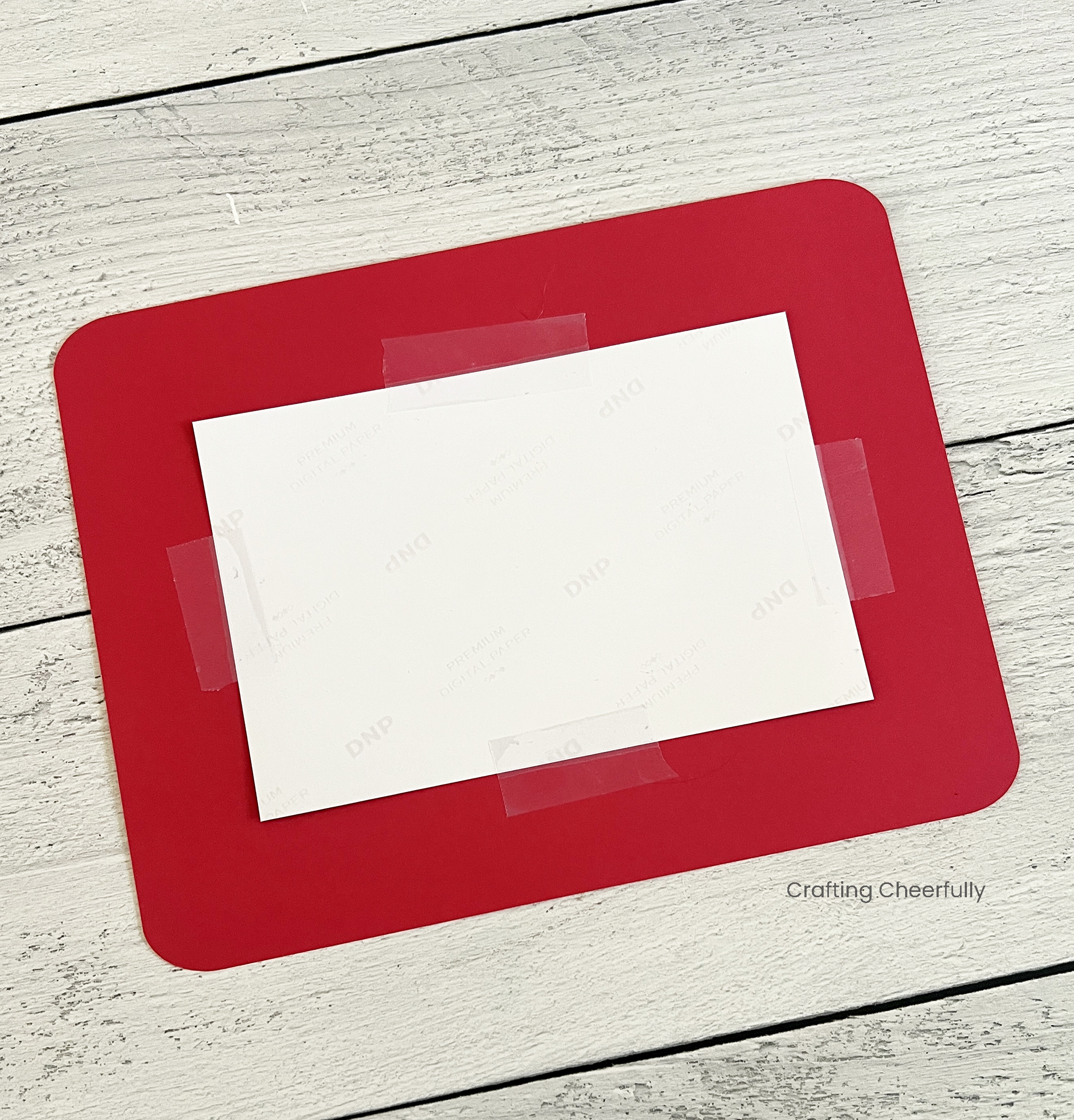 A photo is taped to the back of the paper frame.
