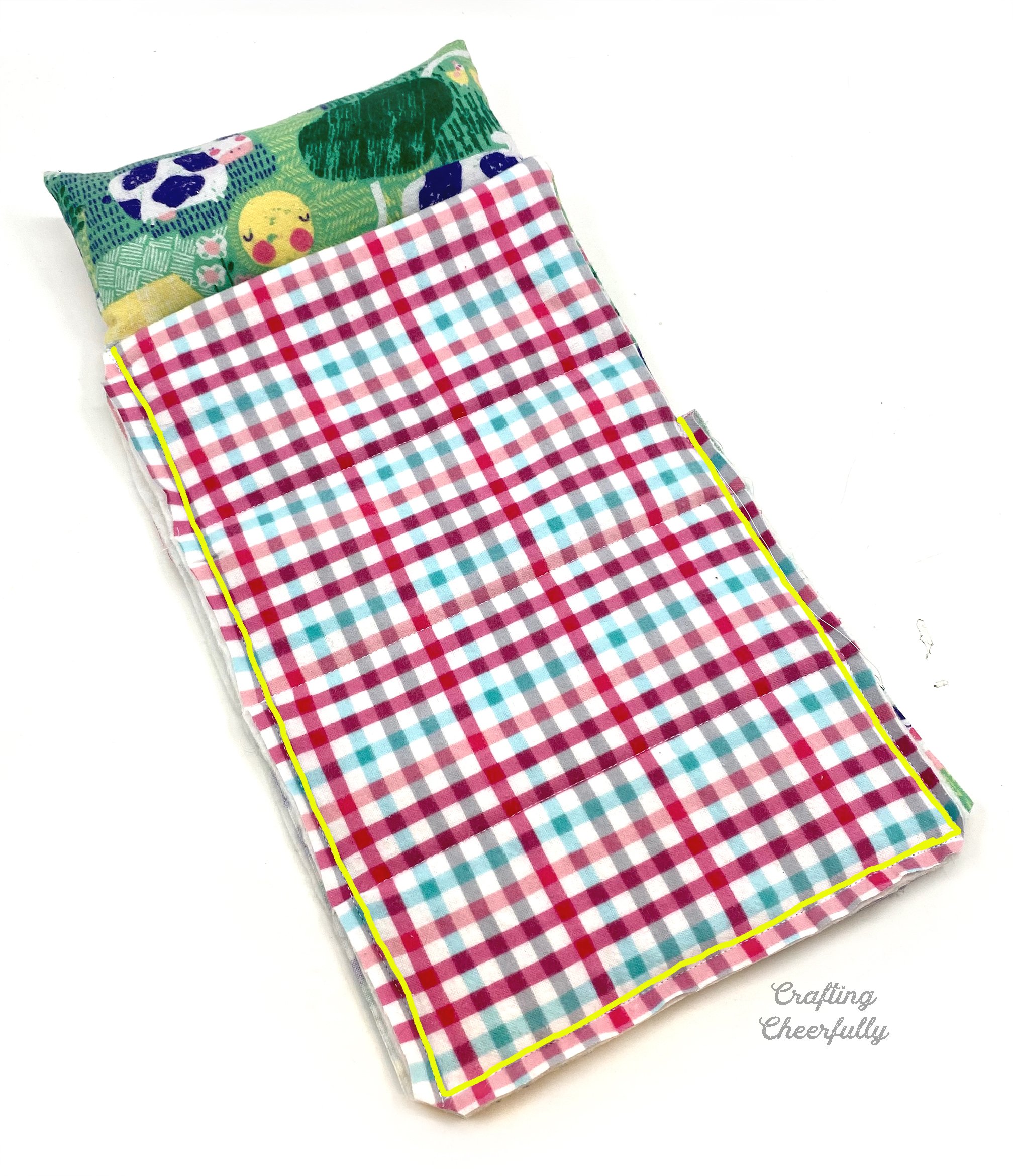 Stitch lines are highlighted in yellow showing how the sleeping bag front and back are attached together.