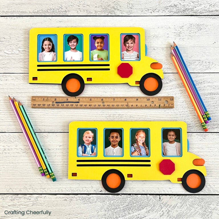 Two layered paper school bus frames with pictures of 4 children in each bus lay next to a ruler and pencils.