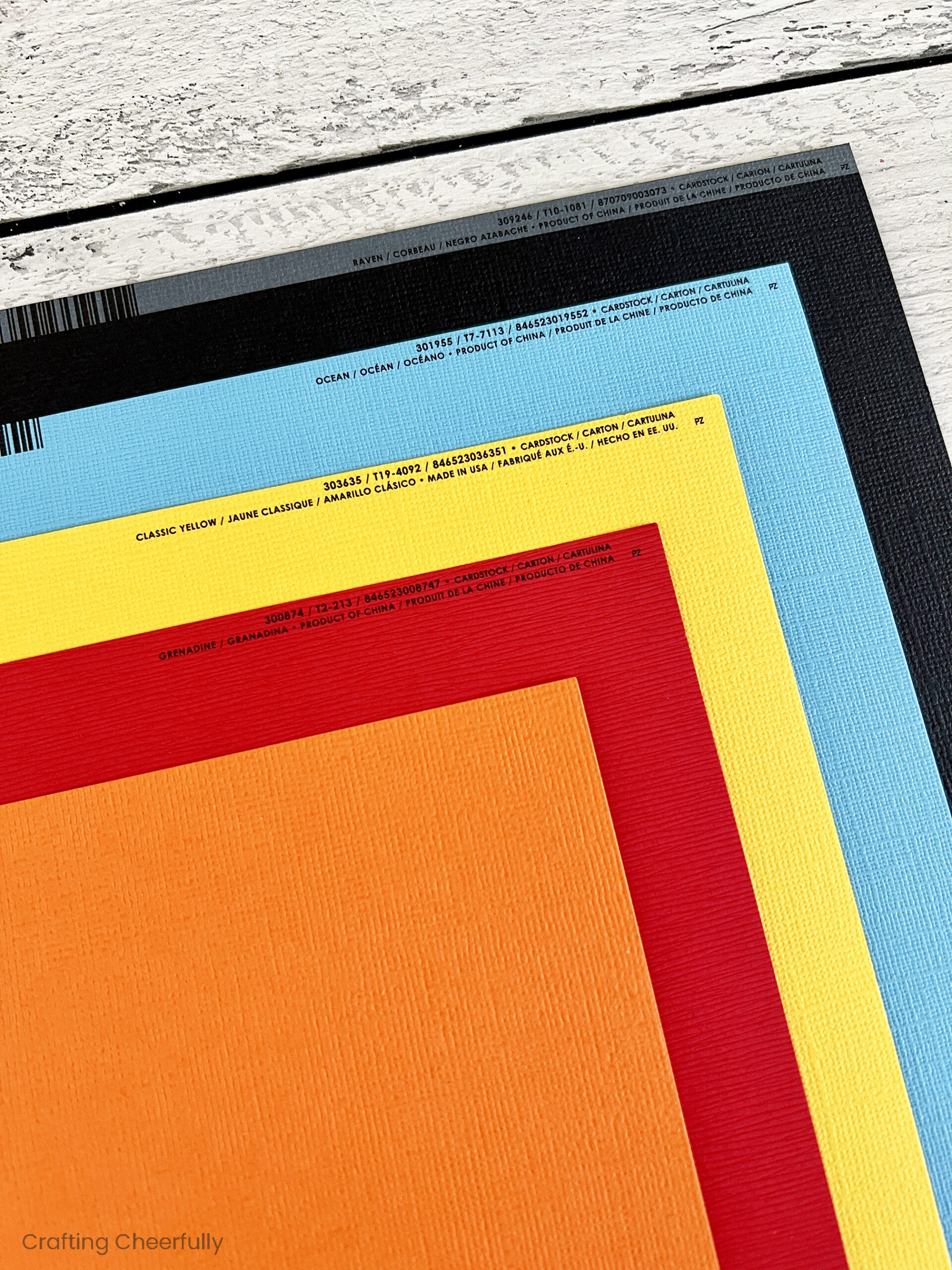 Colored pieces of cardstock including orange, red, yellow, blue and black.