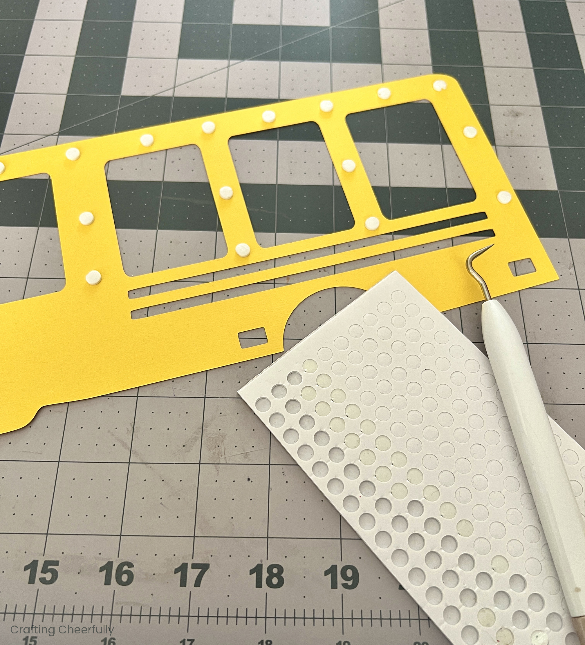 Small foam dots are added to the back of the yellow paper layer.