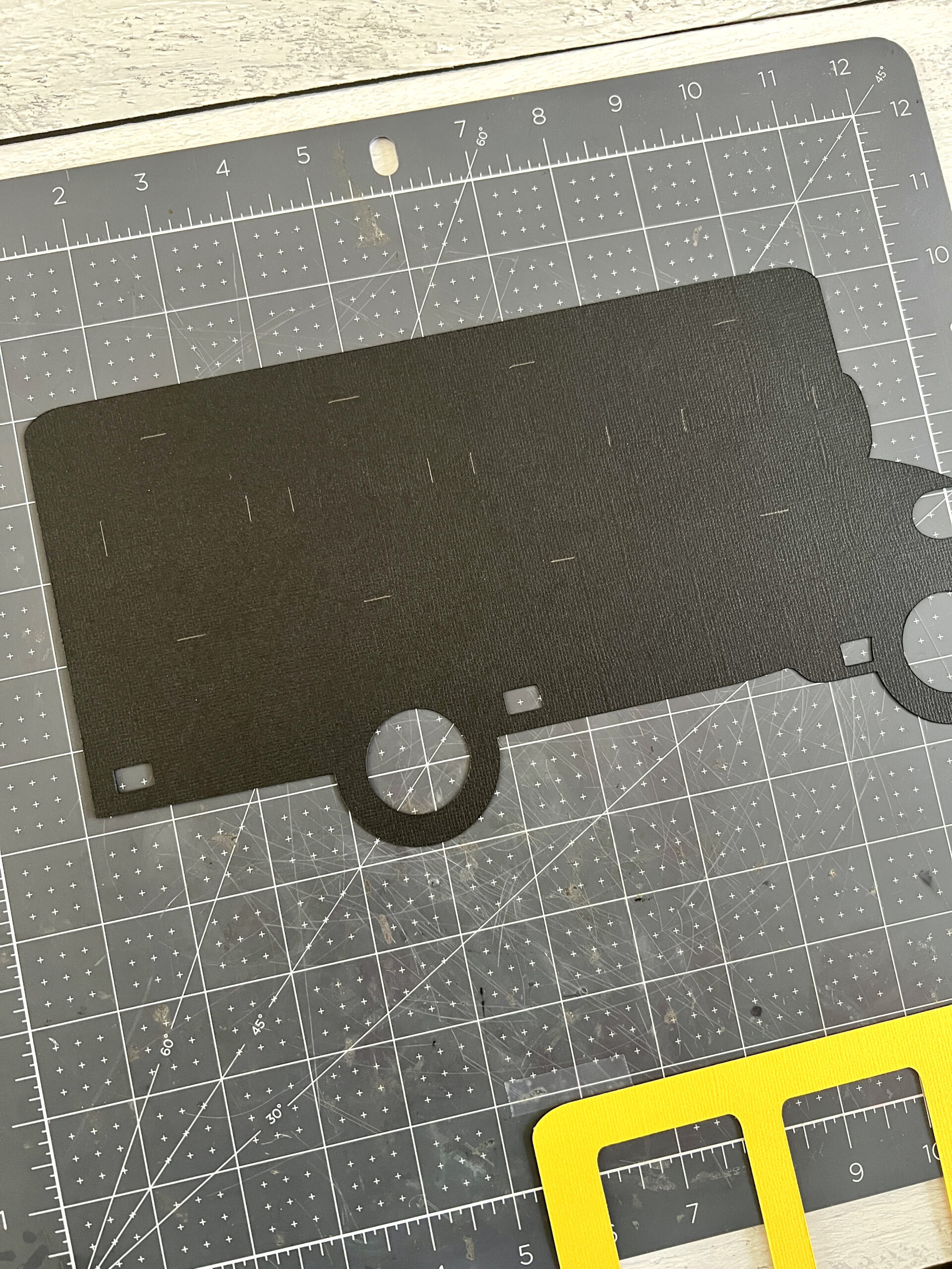 Pencil markings the windows are visible on the black layer of paper.