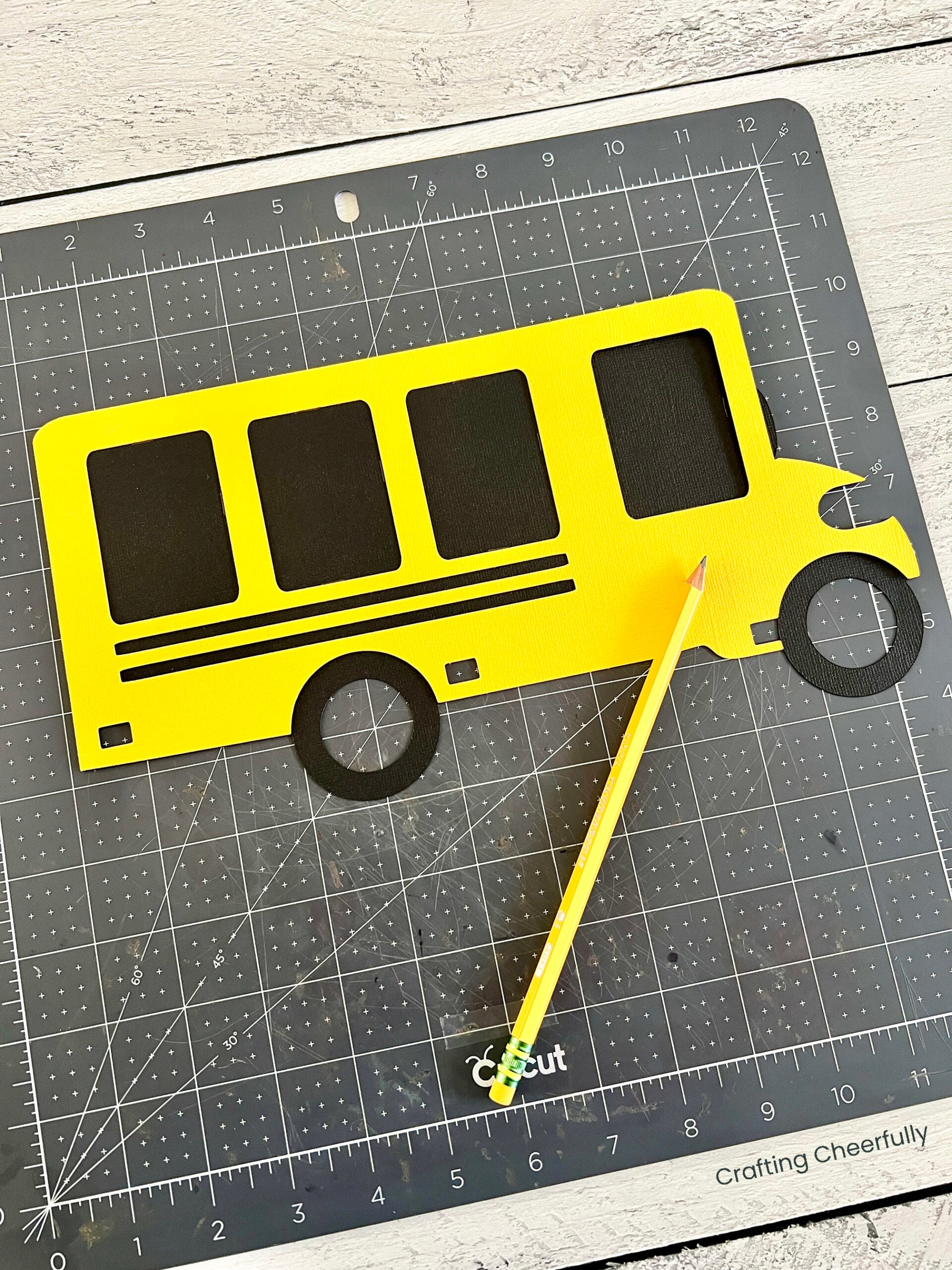 The yellow layer of paper is laid on top of the black one, the windows are traced with pencil.