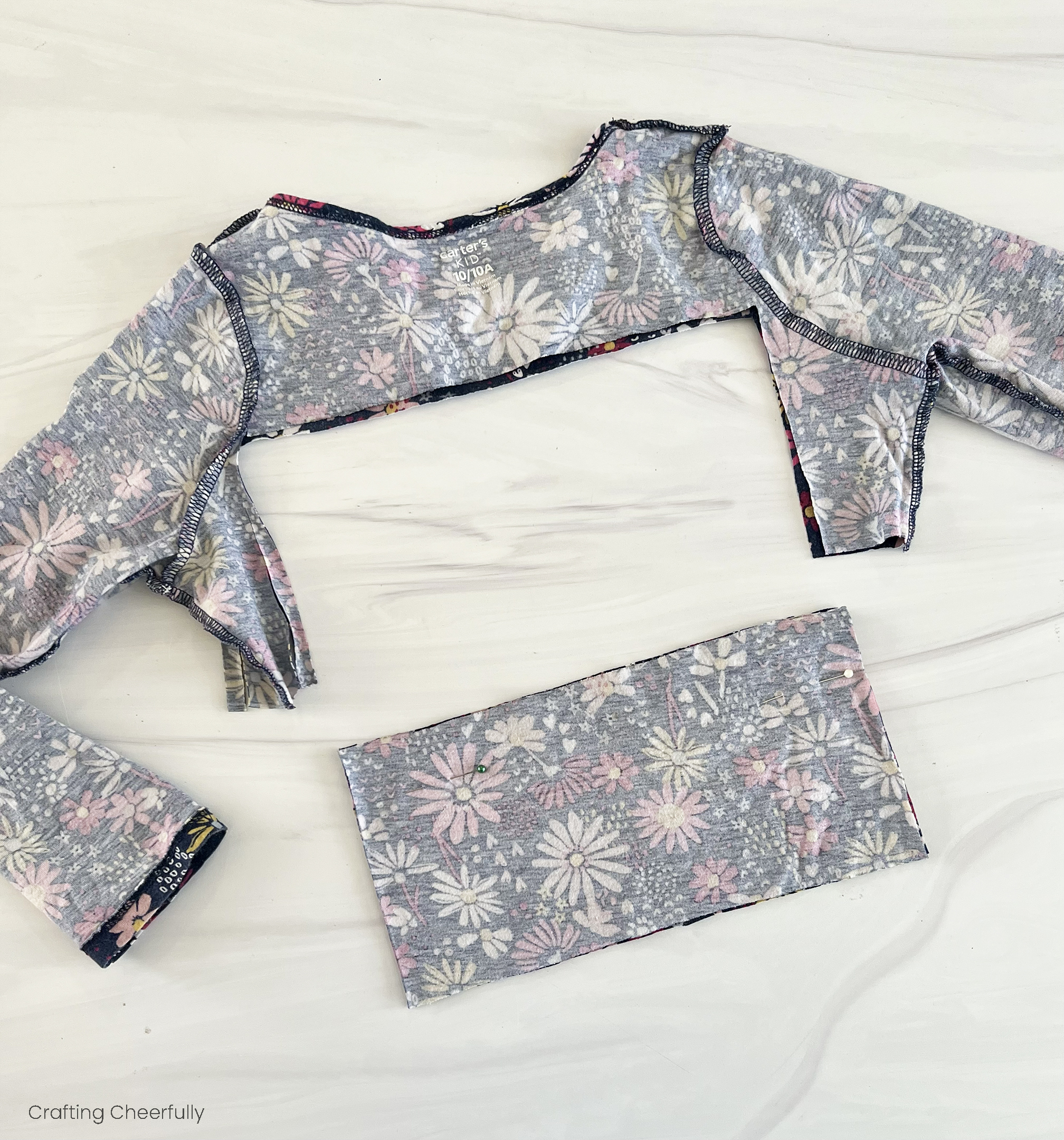 A rectangle is cut from the bodice of a girl's dress.