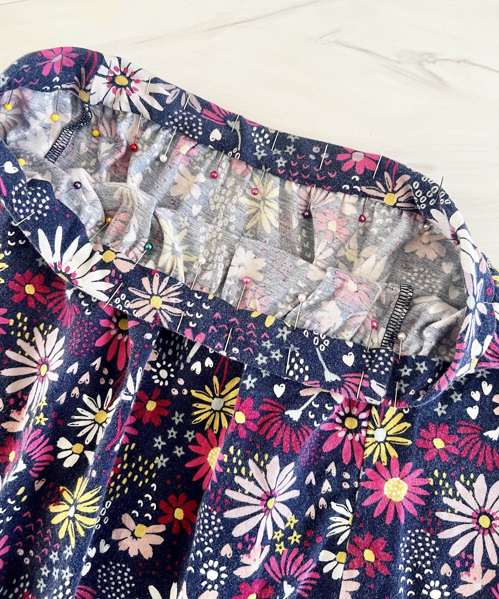 The waistband of the skirt is pinned in place.