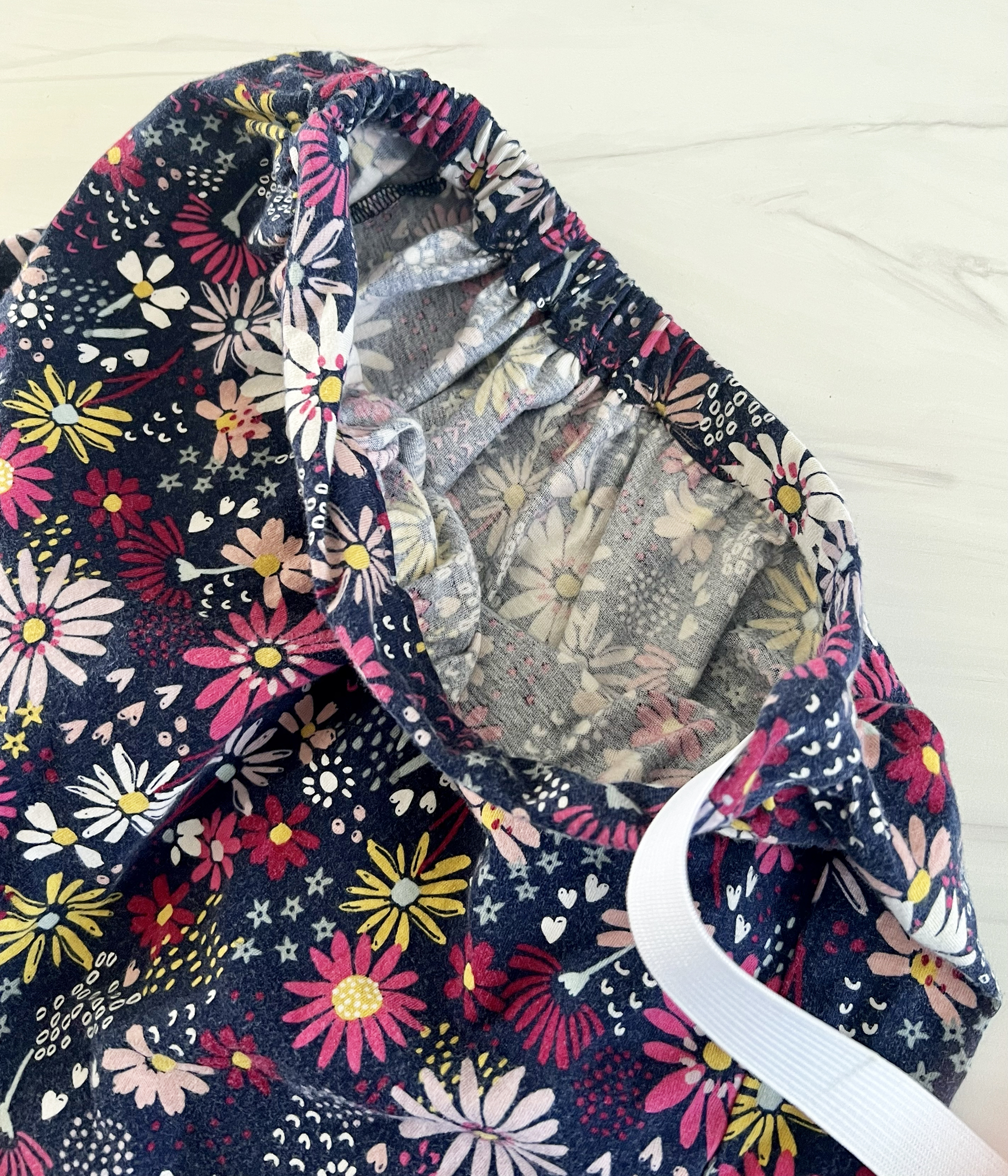 A piece of elastic is being passed through the elastic casing.