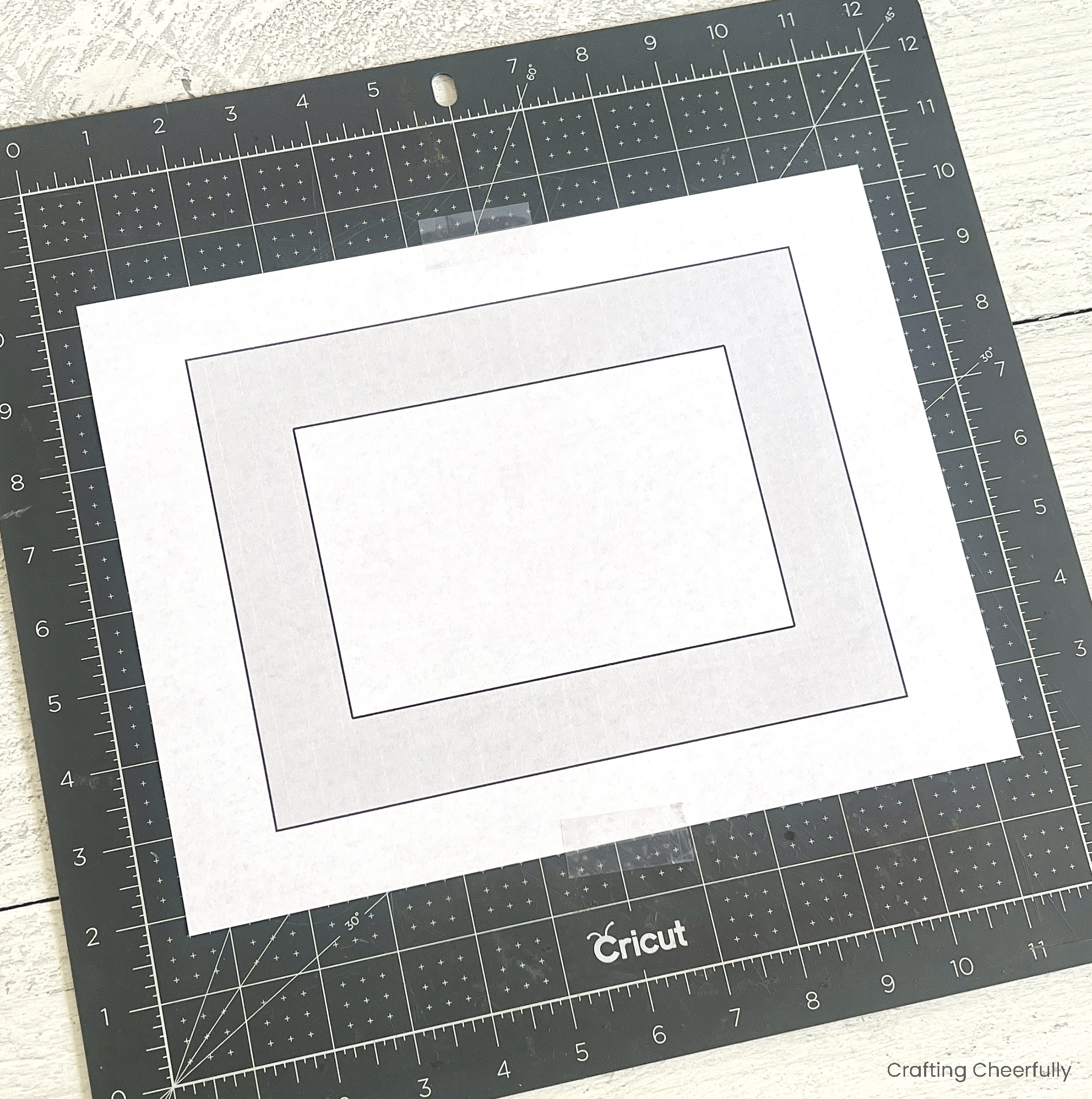 The template is taped to a black cutting board.