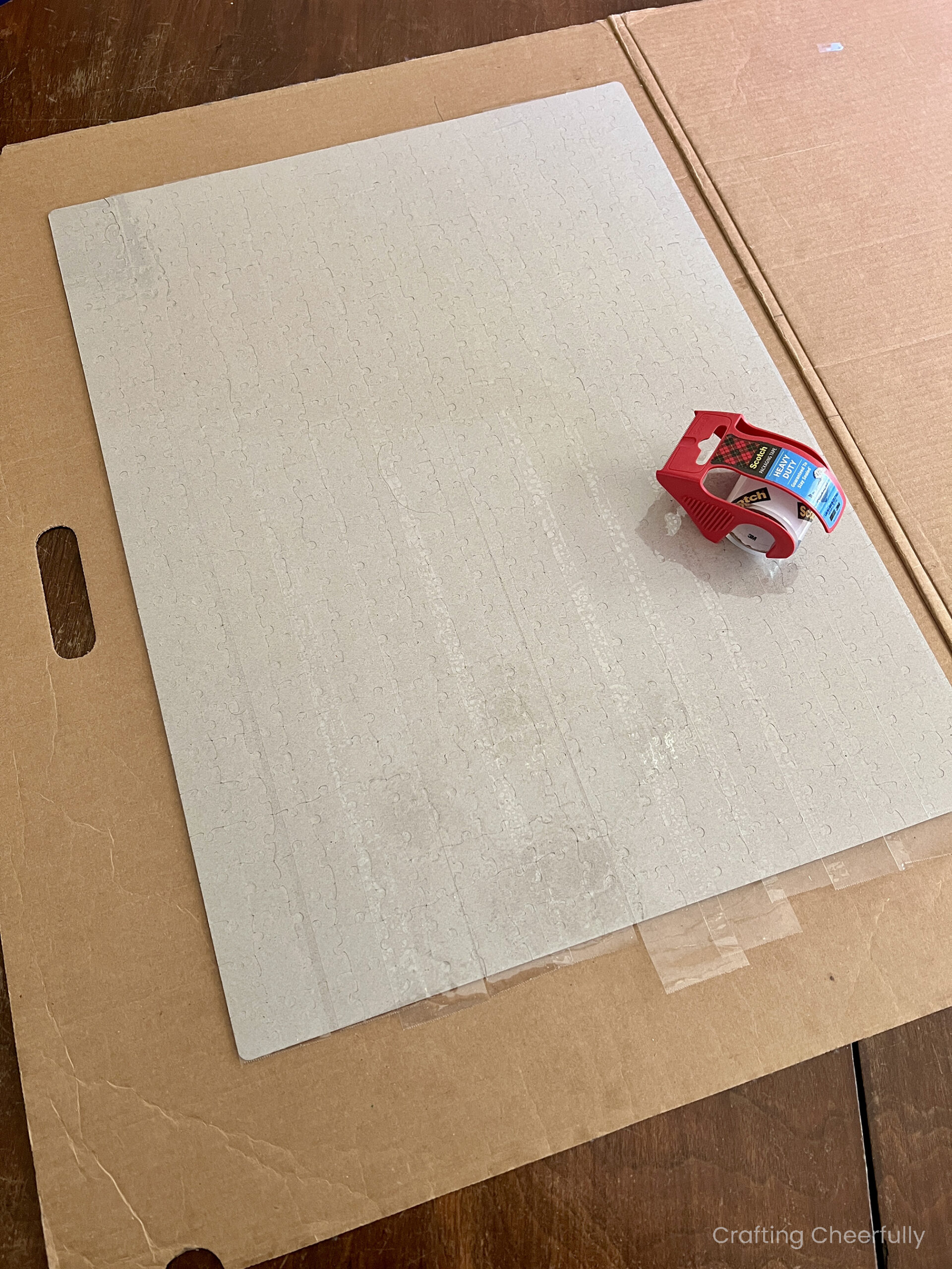 Packing tape is used to cover the back of the puzzle.