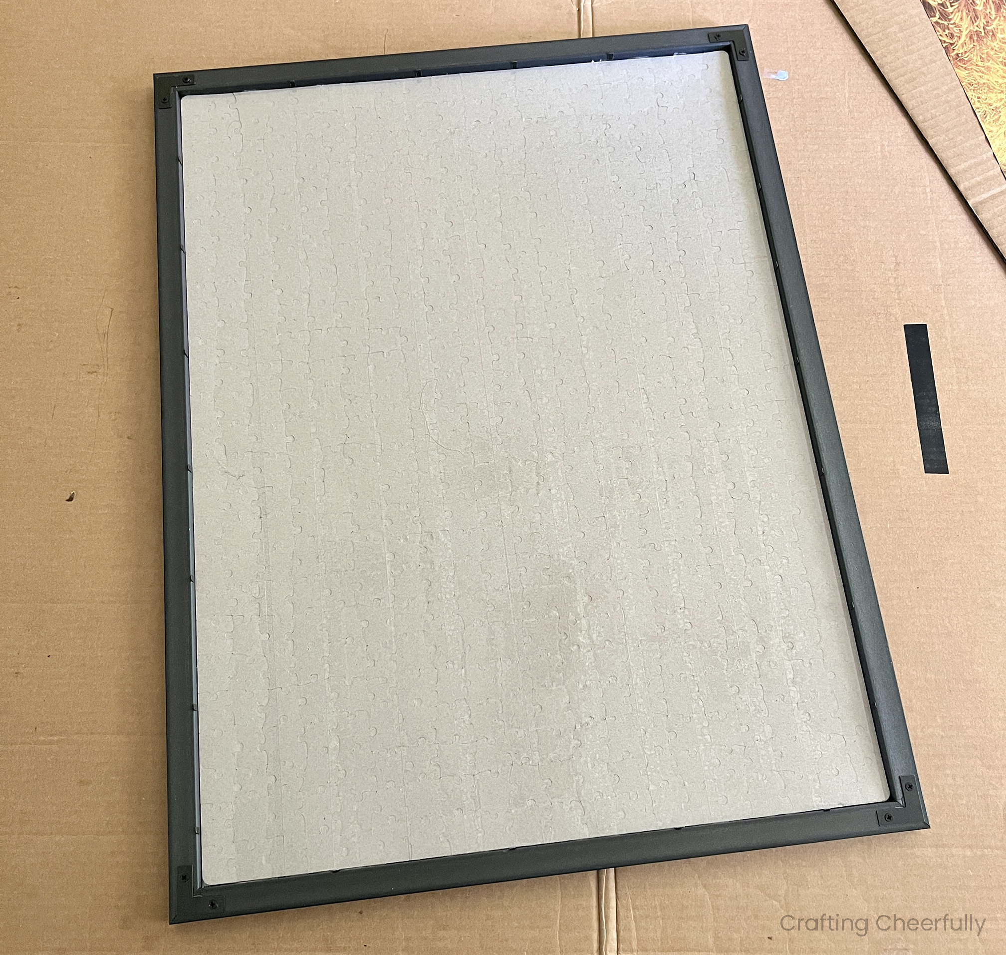 The puzzle is laid into the black frame.