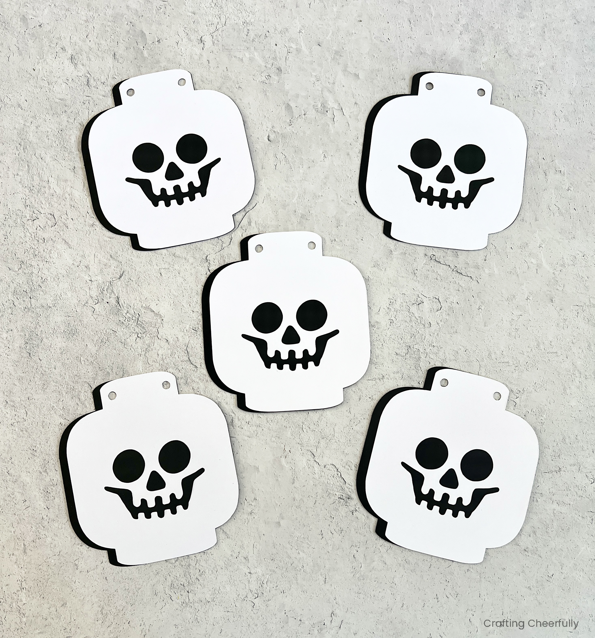 Five lego skeleton heads assembled.