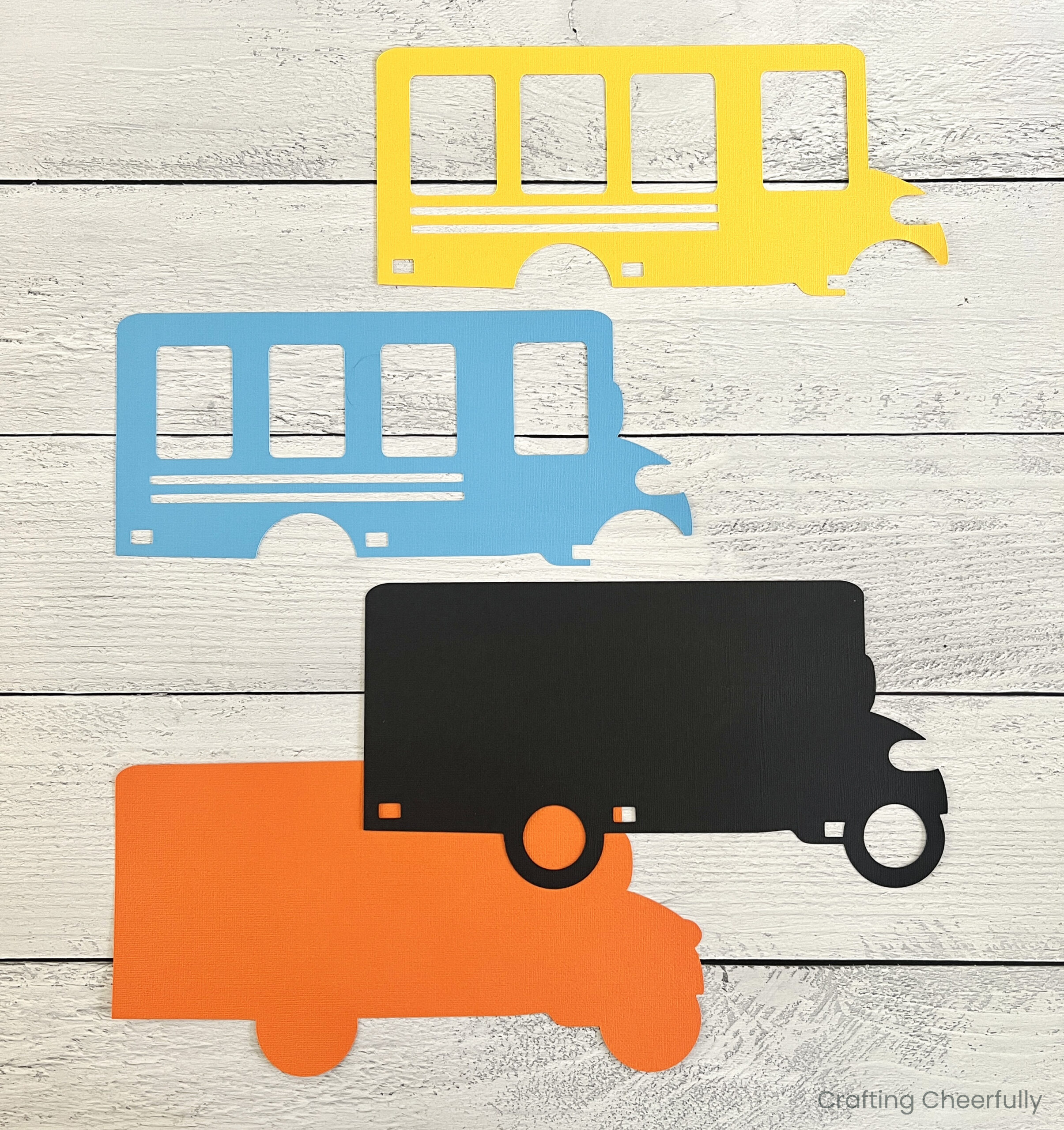 Four paper layers for the school bus placed on a table.