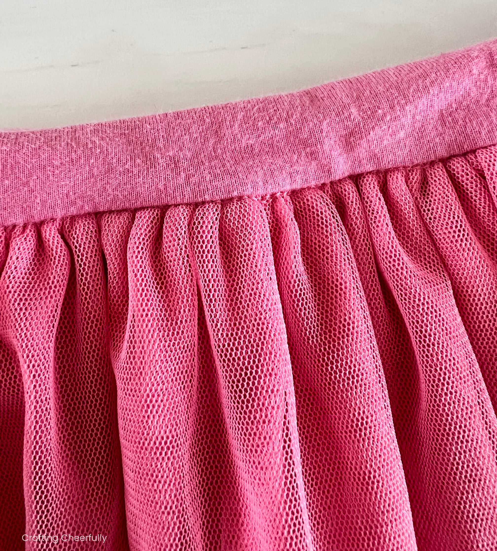 Pink skirt with gathered waist into a waistband.