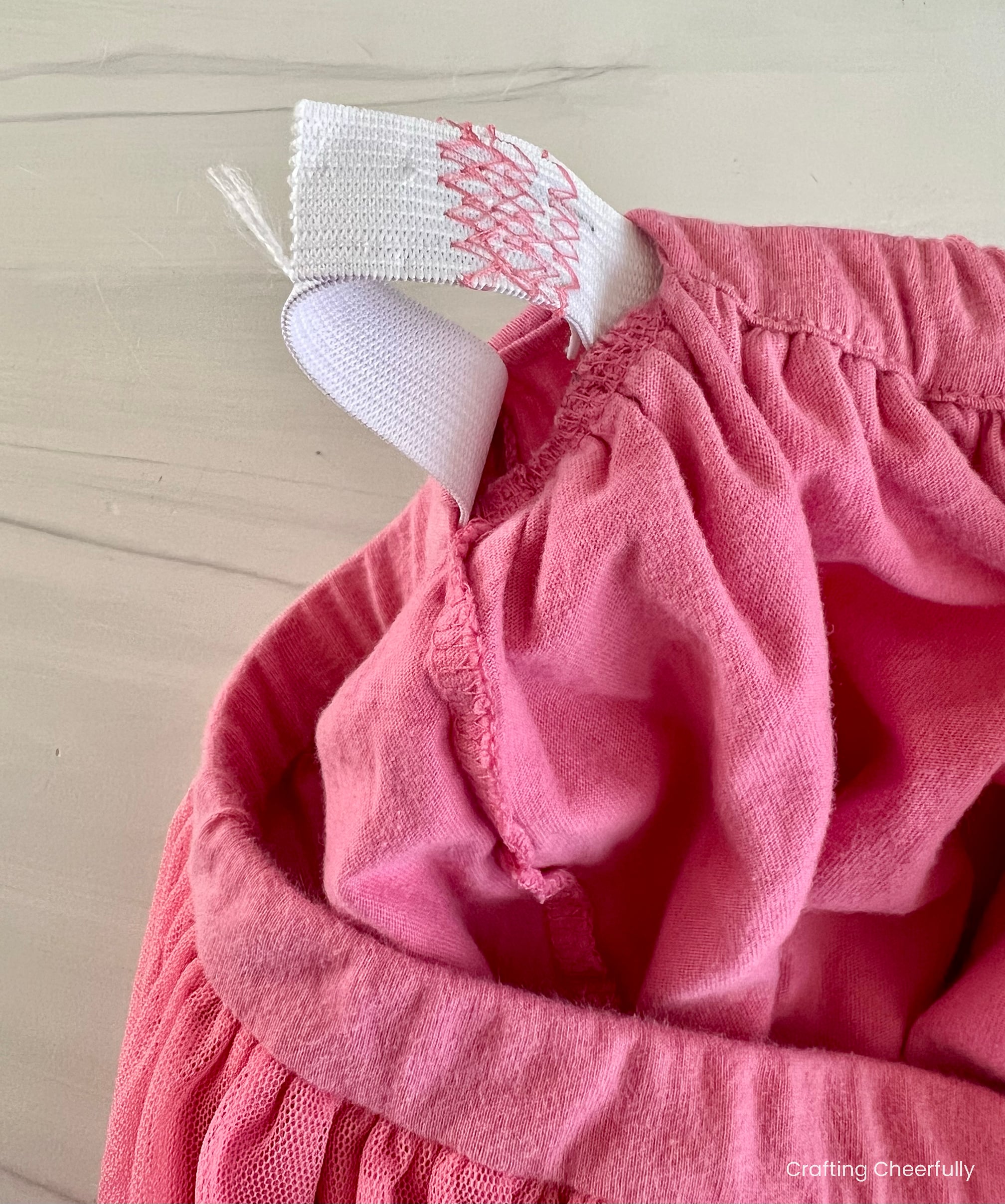 The two ends of the elastic are laid on top of one another and stitched together.