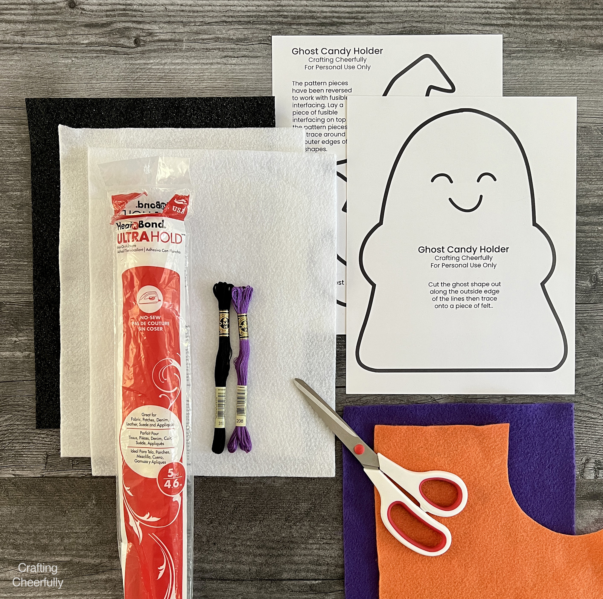 Supplies needed including pattern, felt, embroidery floss, scissors, and interfacing lay on a table.