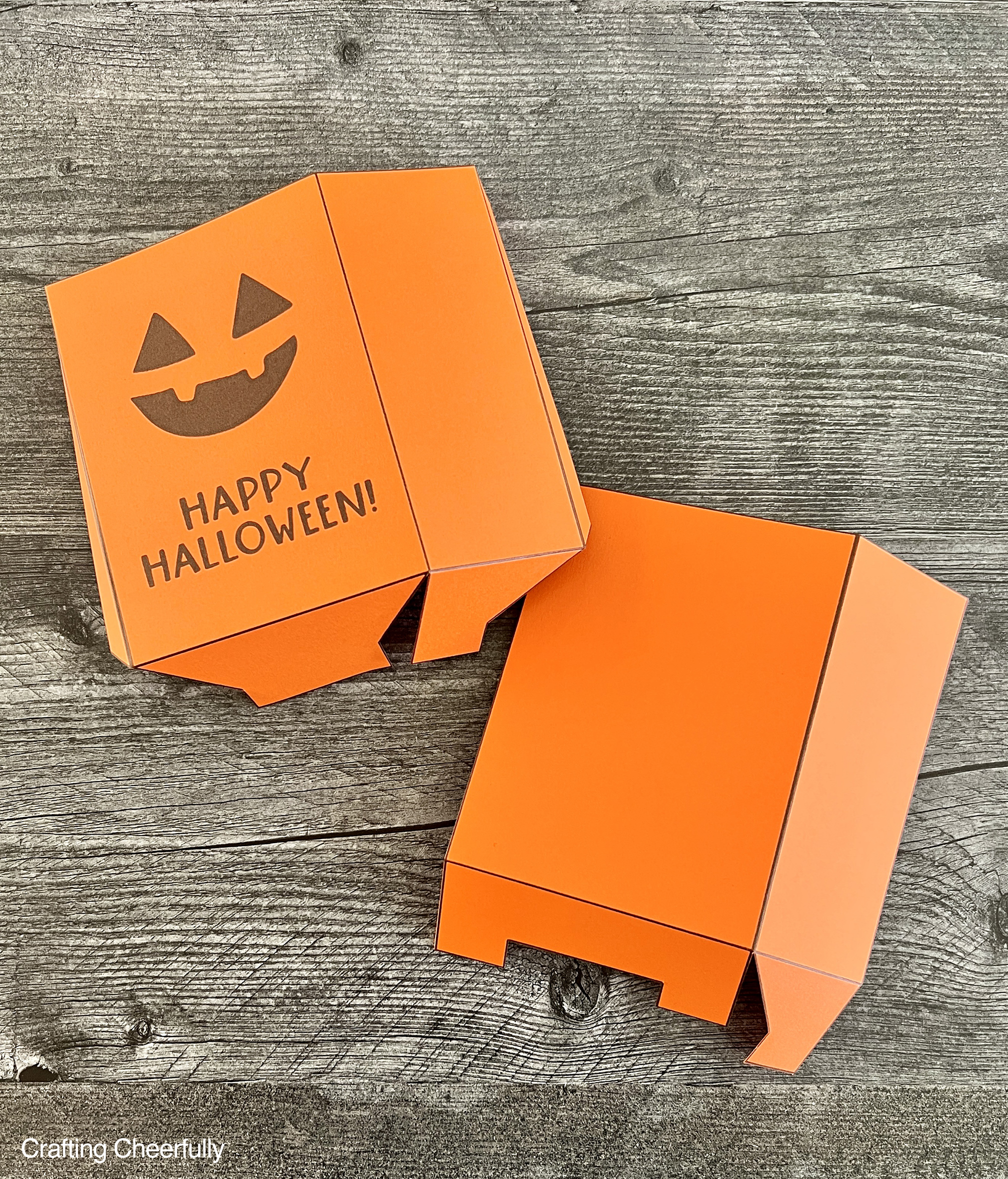 Pumpkin treat boxes are folded along the score lines.
