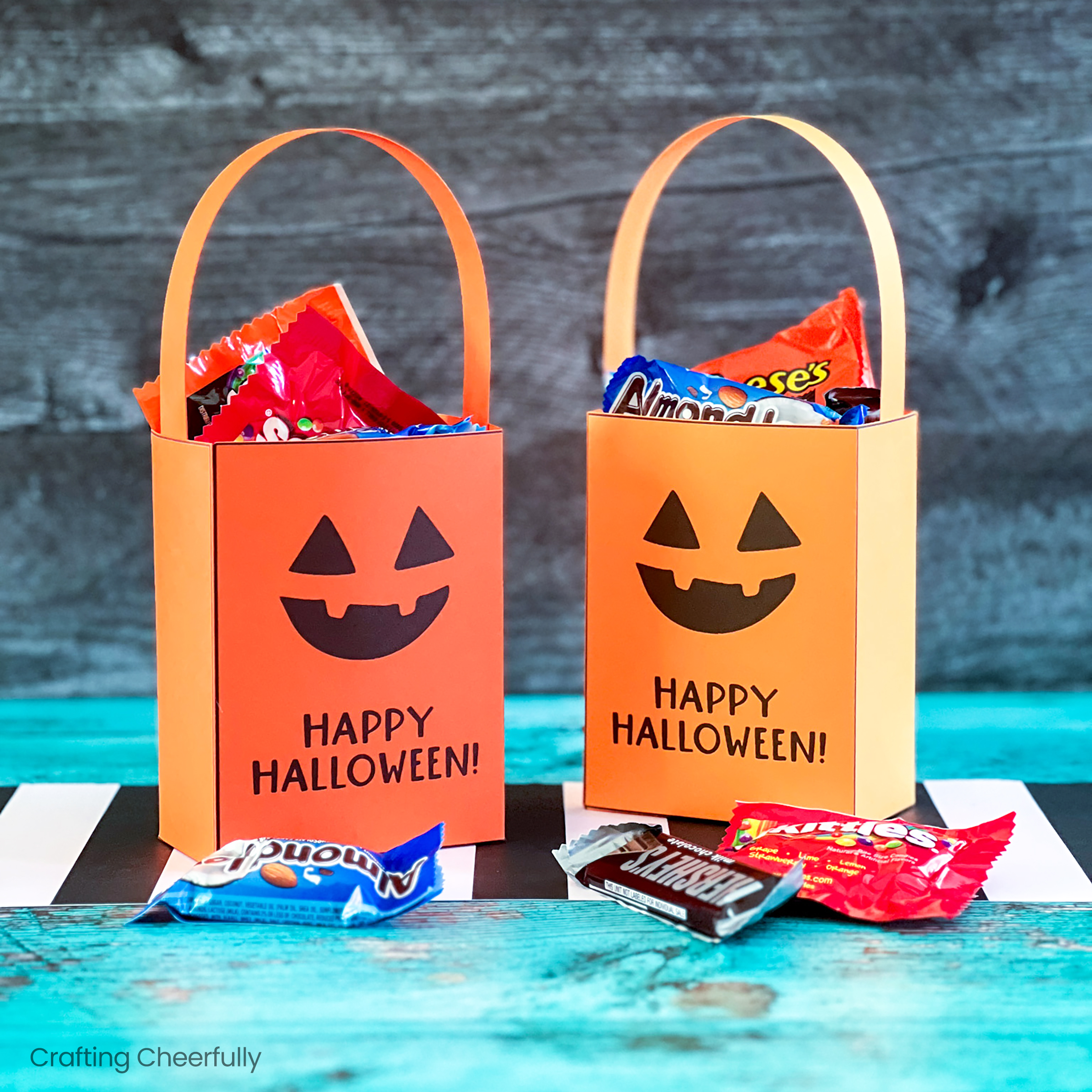 Two range Jack-o'-lantern pumpkin treat box filled with candy.