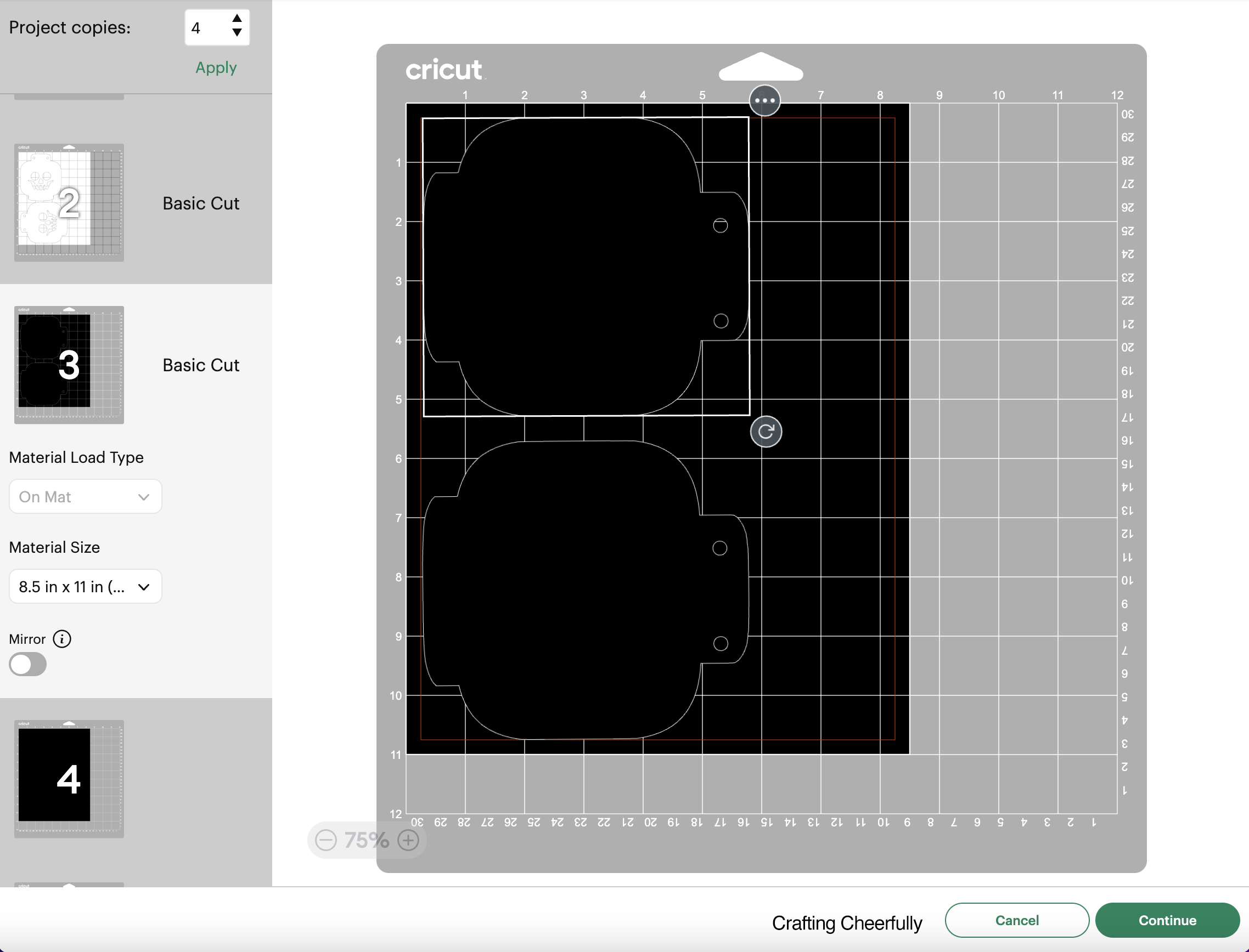 Two of the bottom layer pieces of the skeleton banner are arranged on a black mat in Cricut Design Space.