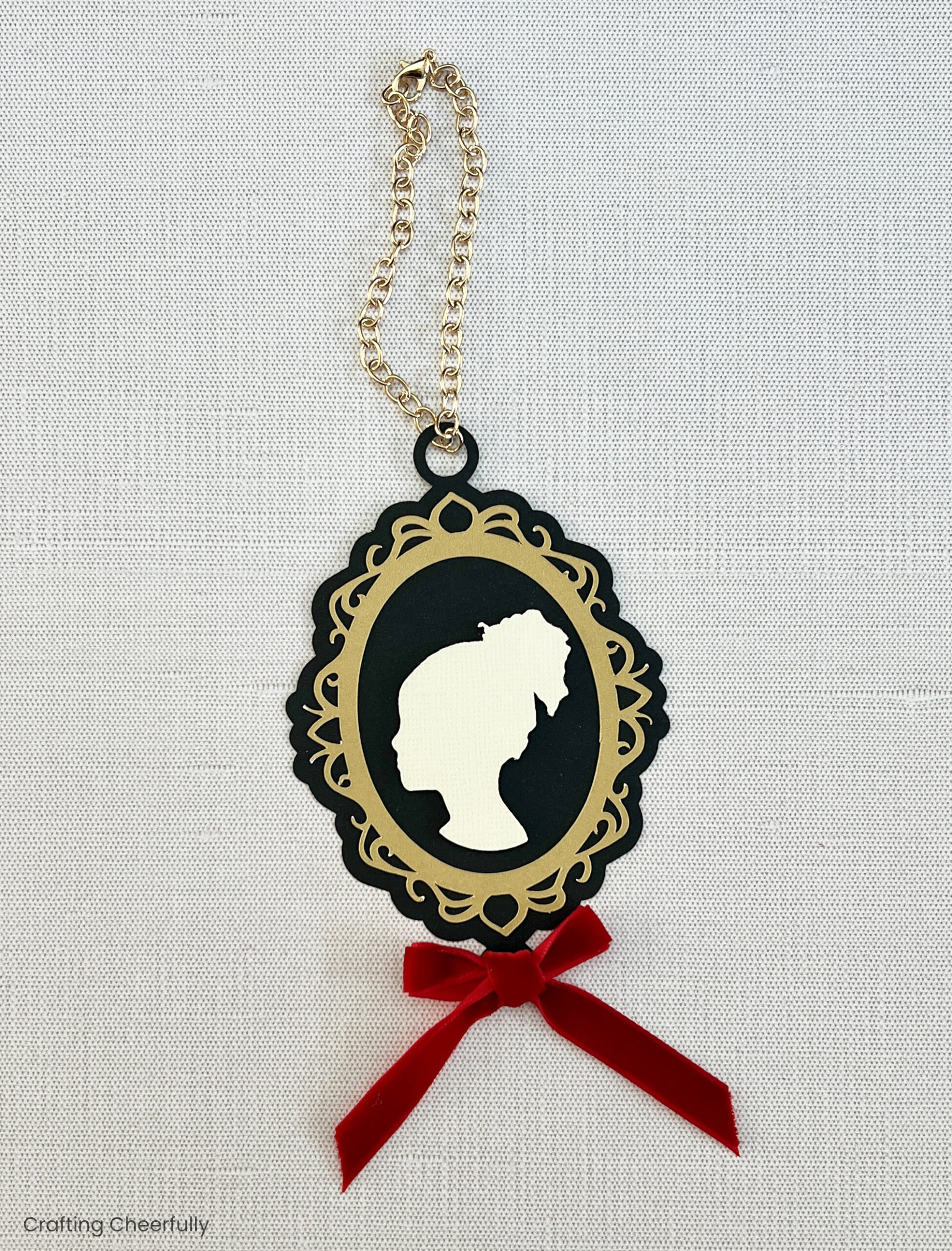 A gold chain bracelet is added to the top of the ornament as a hanging loop.