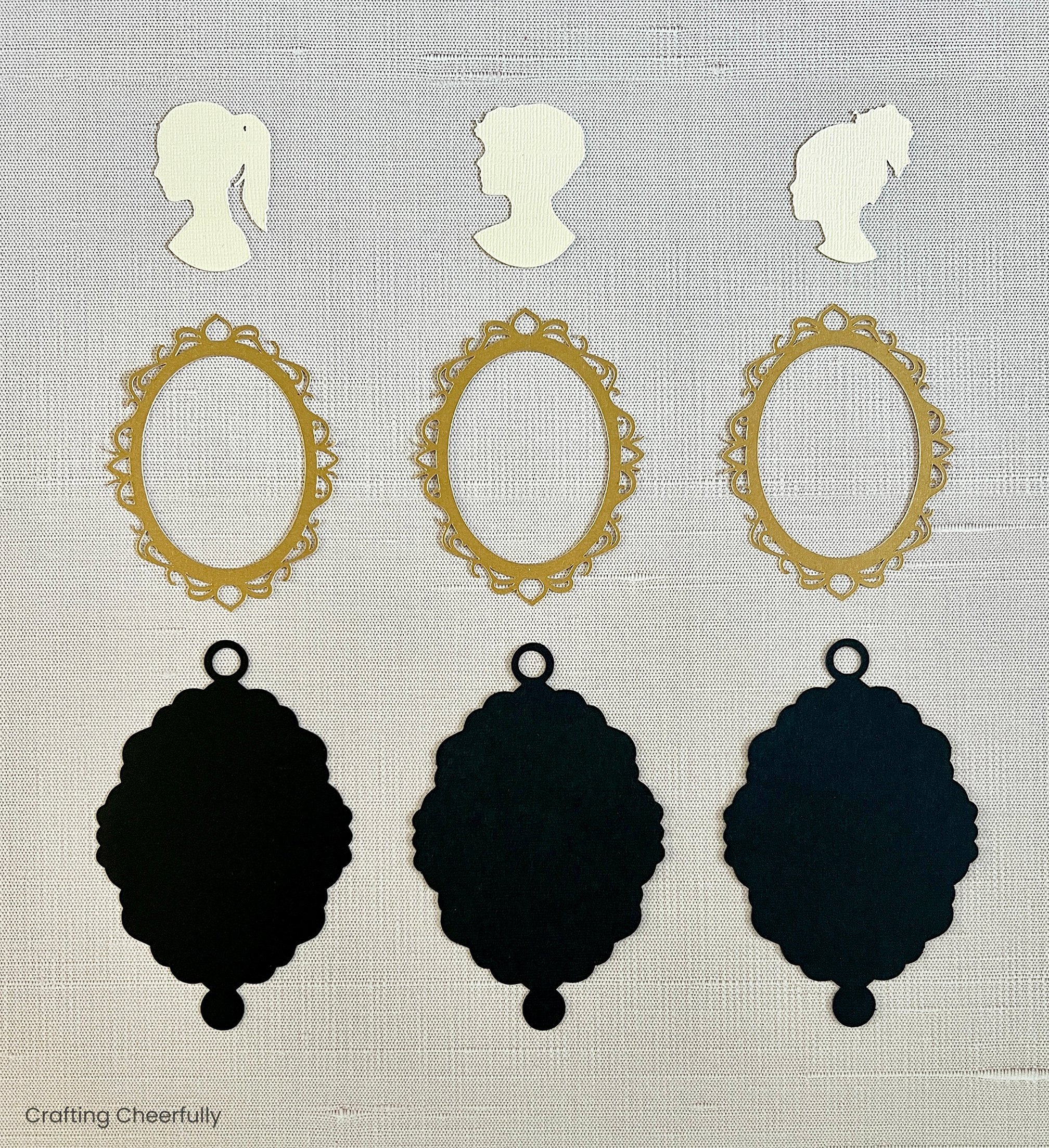 The pieces of the cameo christmas ornament are cut out and arranged in columns.