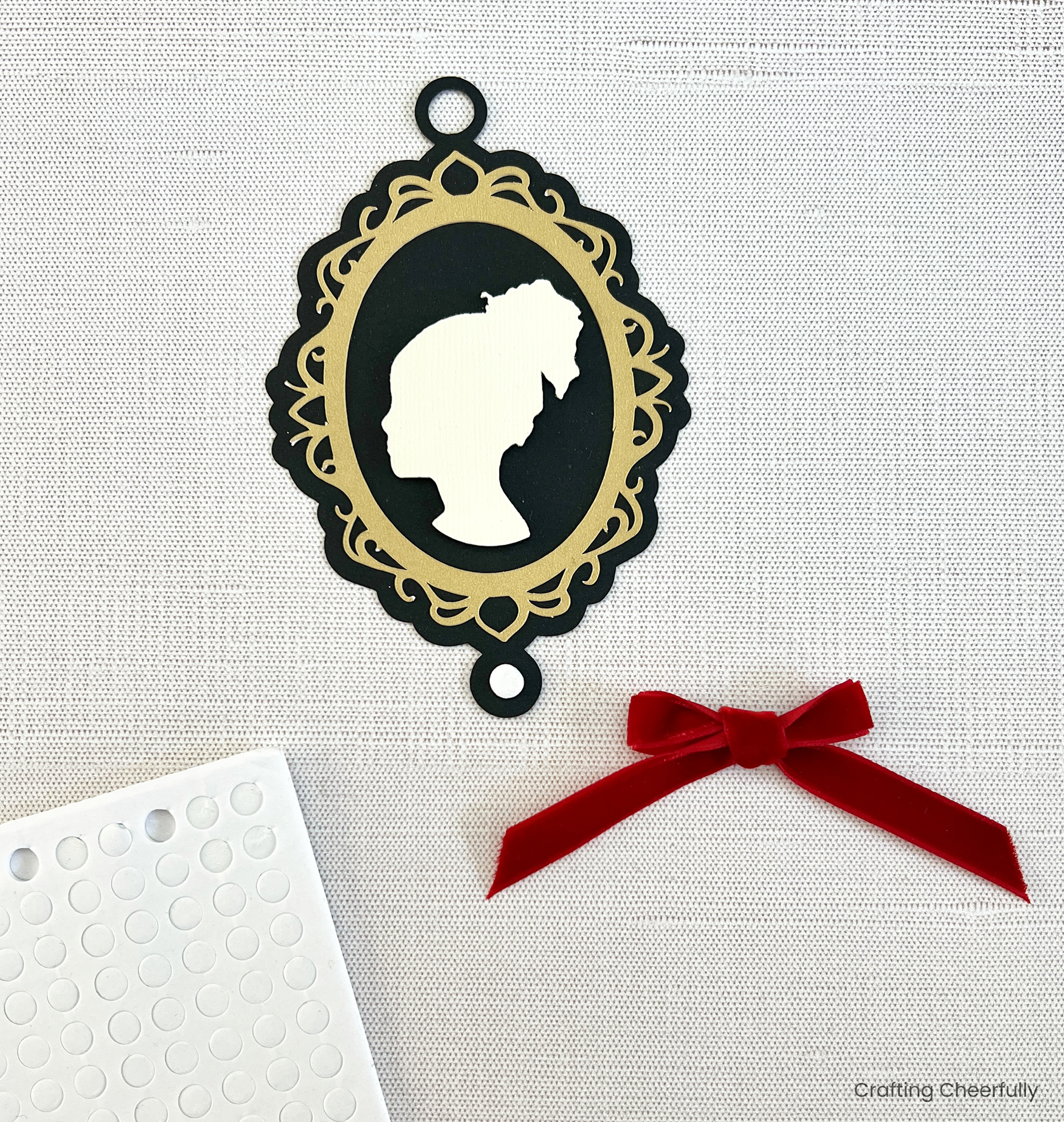 A foam dot is added to the bottom of the cameo ornament.