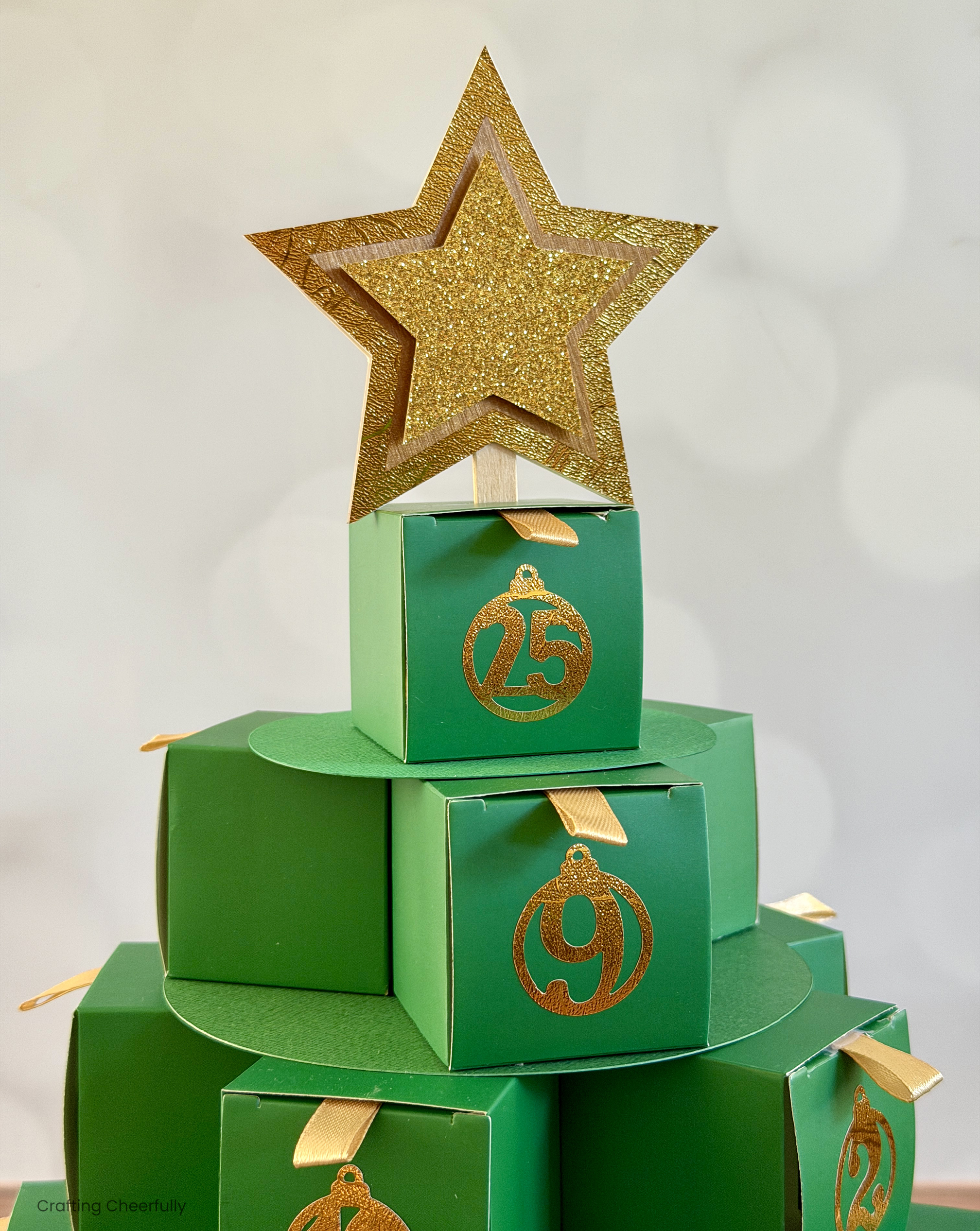 A gold paper star tops the Advent Calendar Christmas tree.