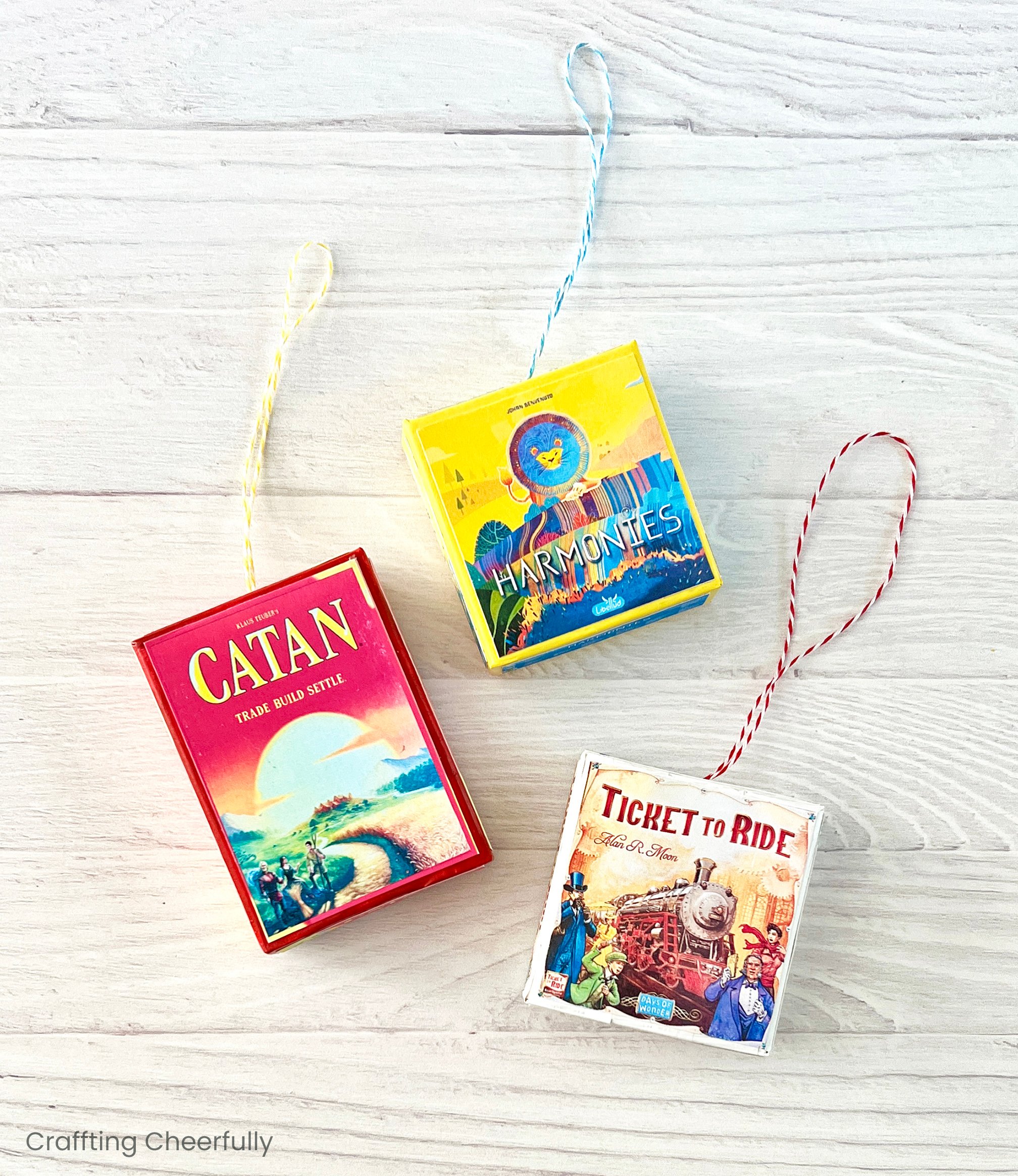 Three board game ornaments with hanging loops.