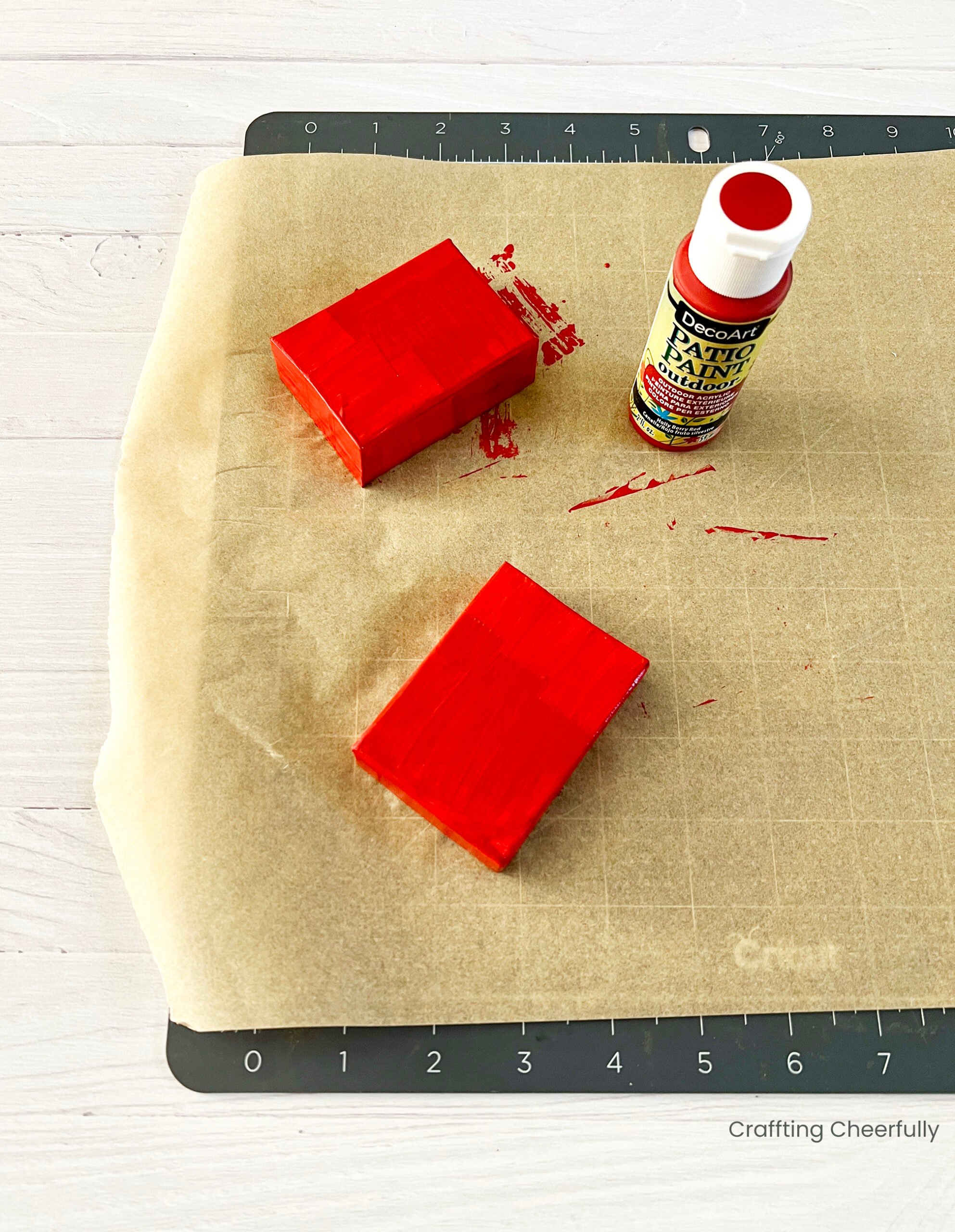 A box base and lid are painted red with red acrylic paint.