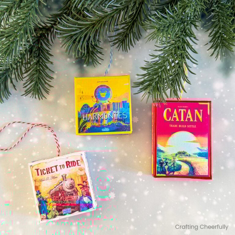 Three handmade board game ornaments.