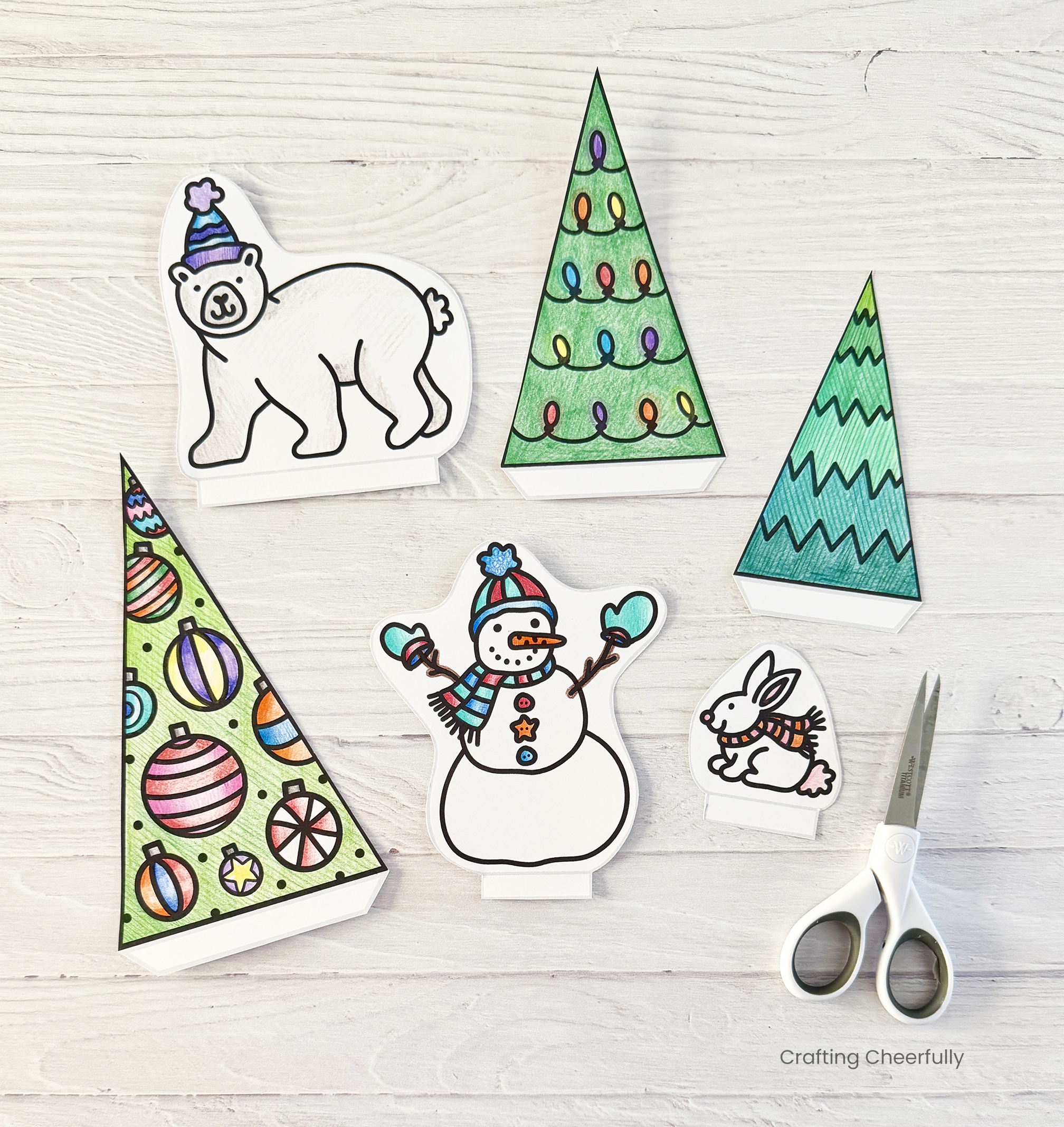 The figurines including a polar bear, snowman, rabbit and trees are cut out.