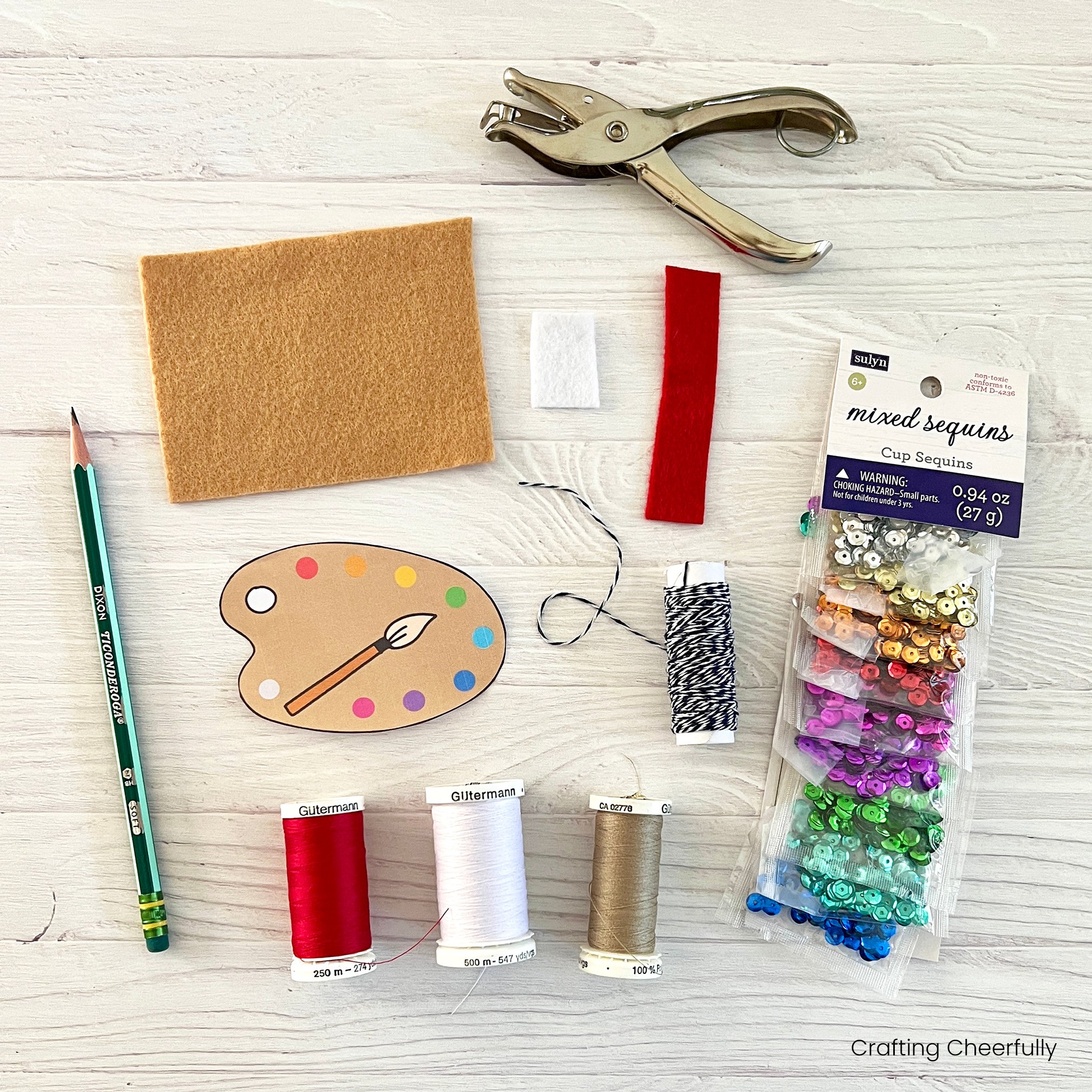 Supplies needed for the felt paint palette ornament including felt, sequins and thread.