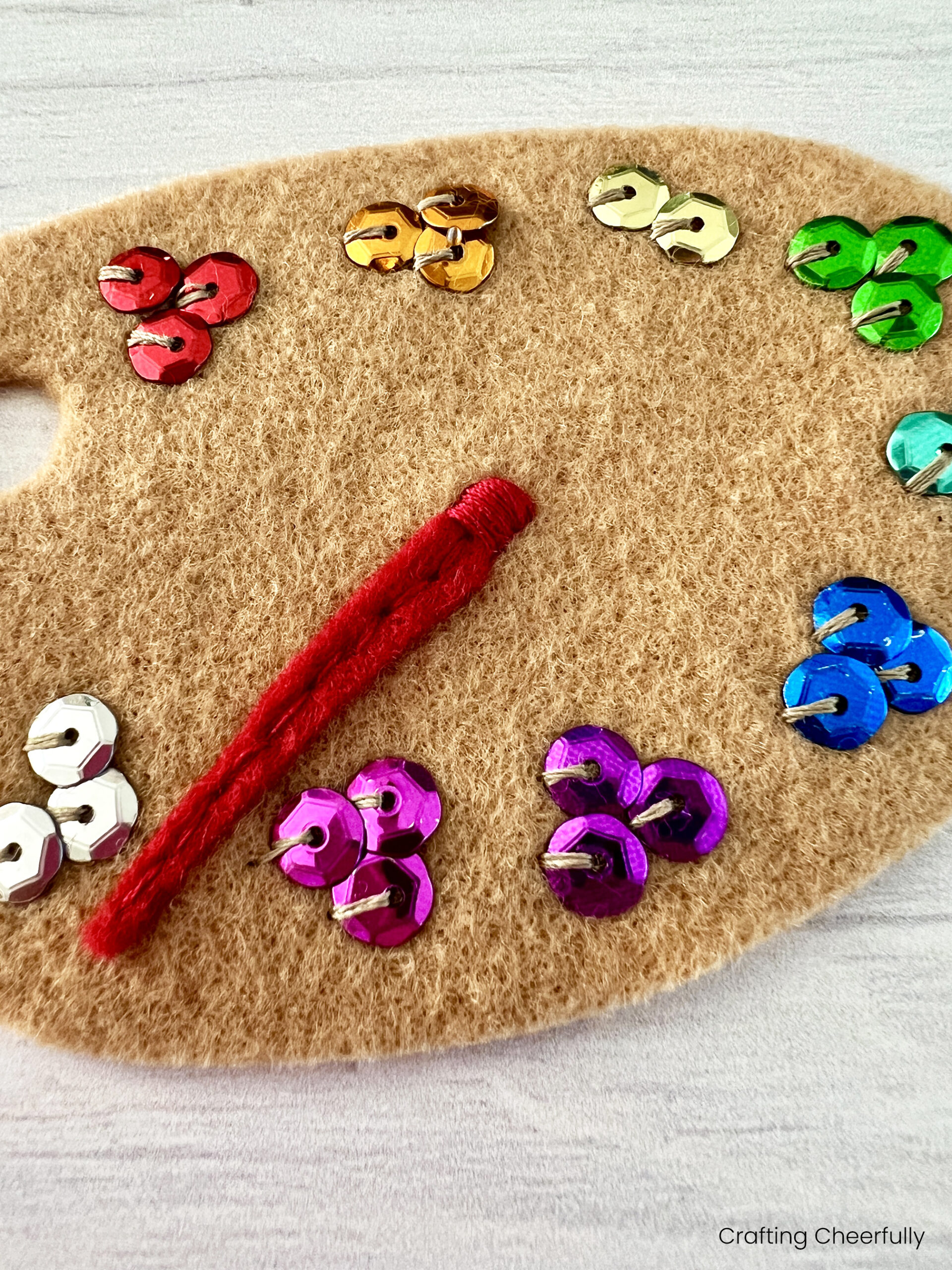 The top of the paint brush is wrap with red thread.