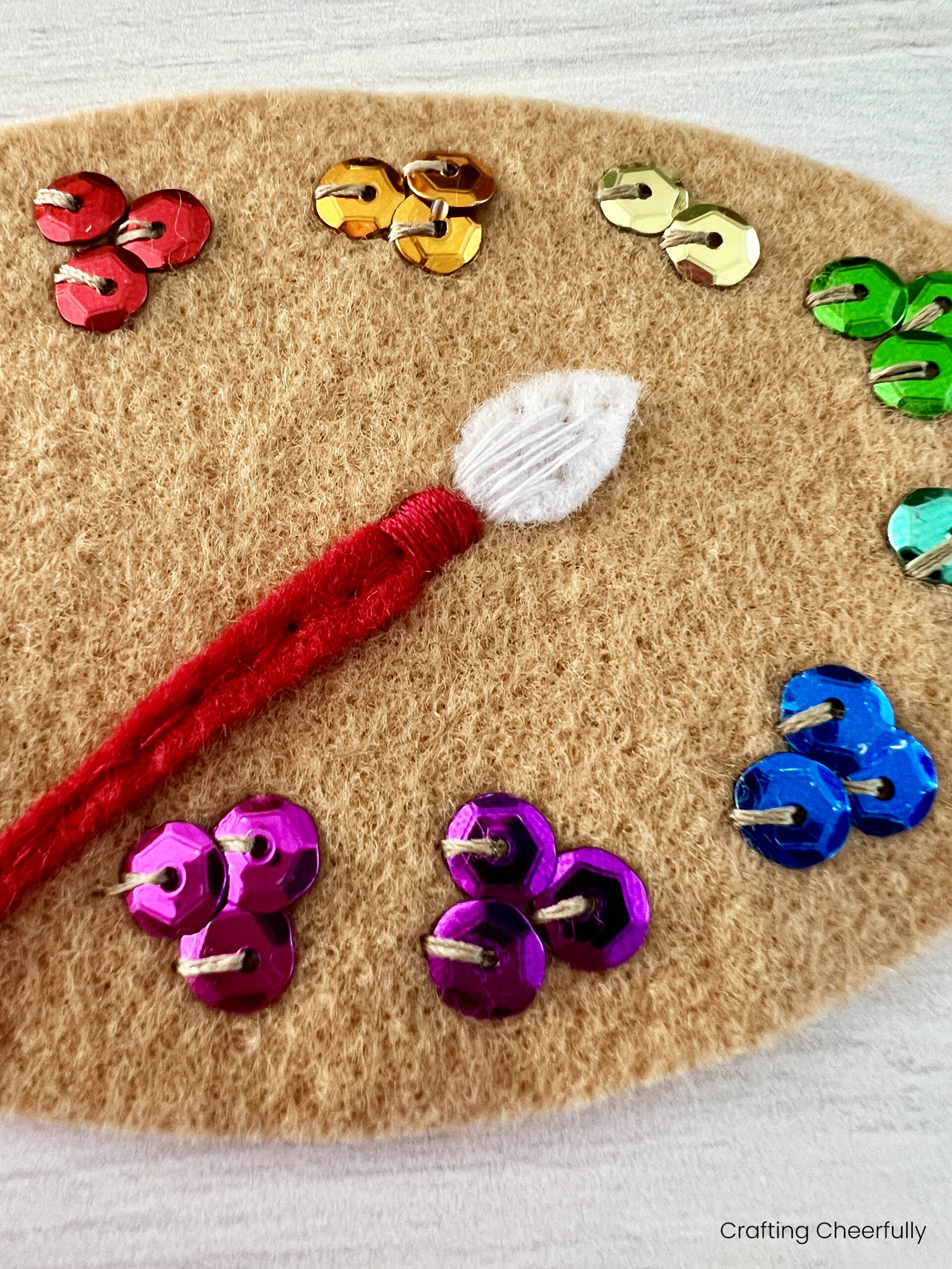 The white brush is added to the paint brush using white thread.