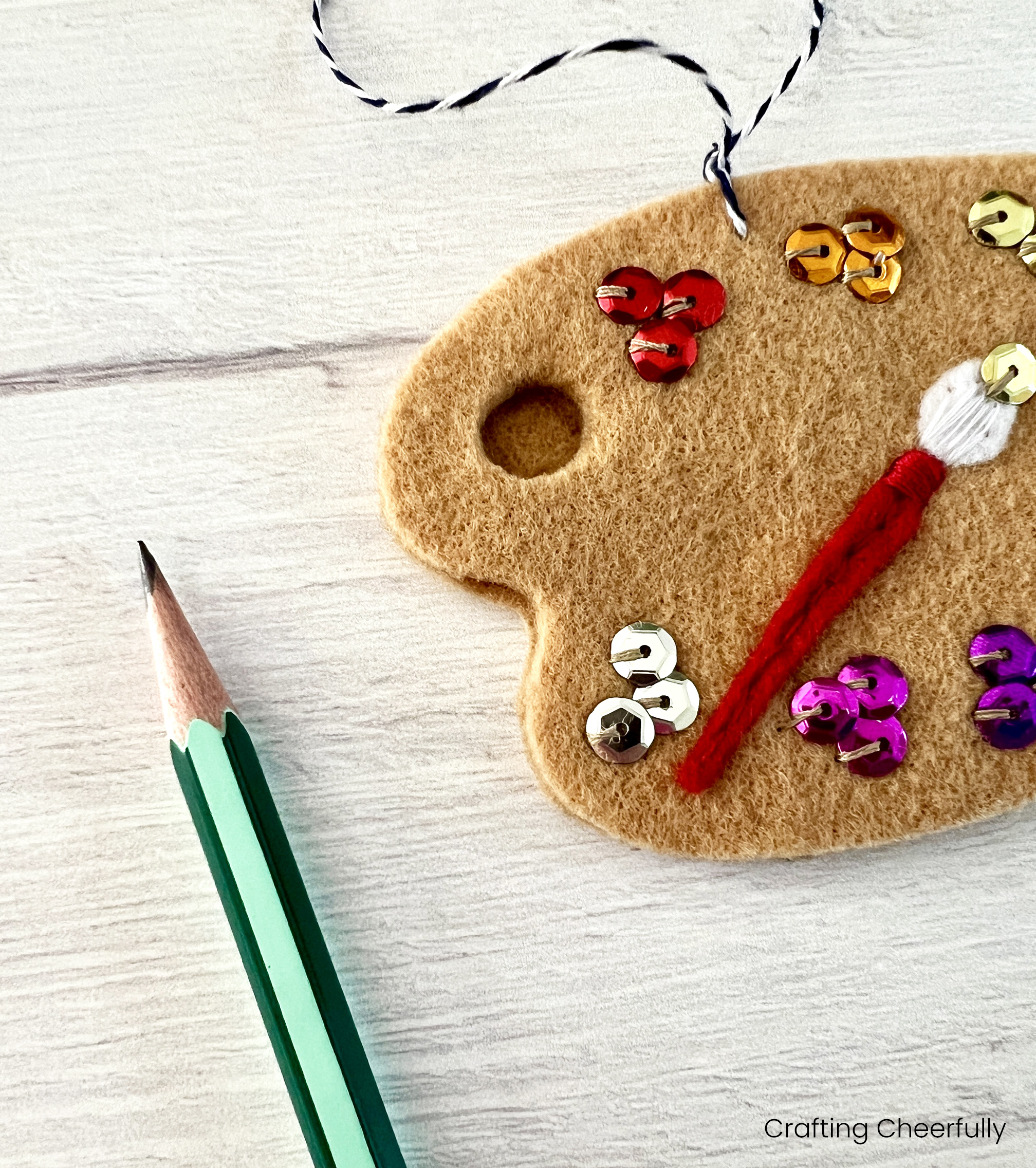 A pencil is used to transfer the hole from the first paint palette to the second.