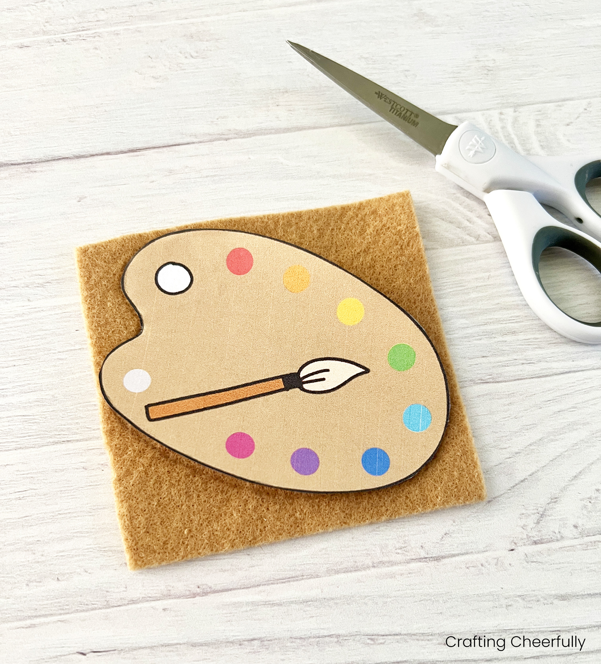 The paint palette template is placed face down on a piece of tan felt.