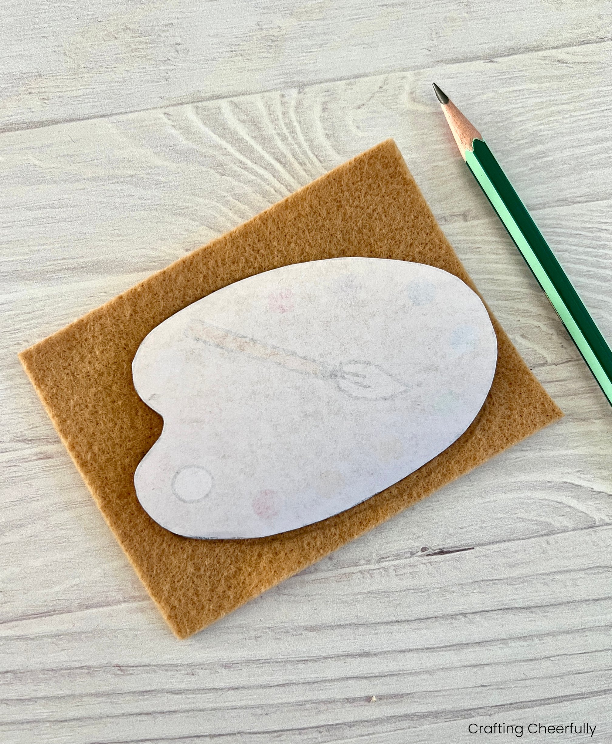 The template is placed face down on a piece of tan felt.