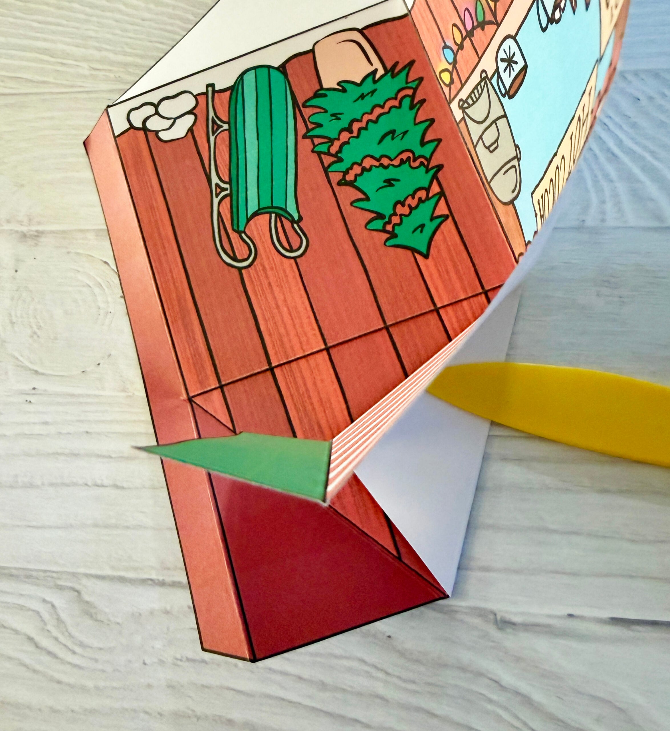 A stylus is used to smooth the fold line on the treat box.