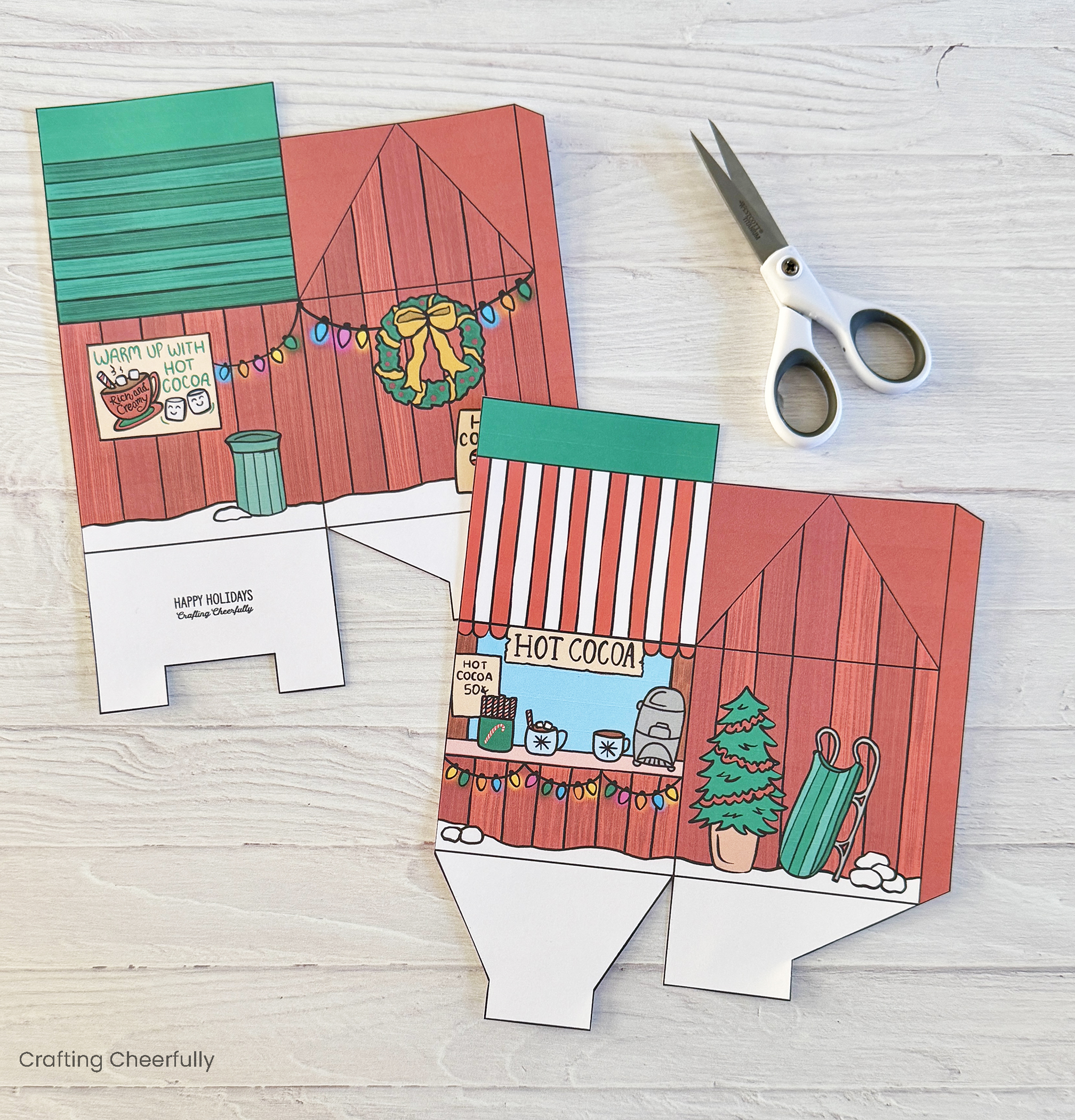 Two printed pieces for the treat box are cut out with a scissors.