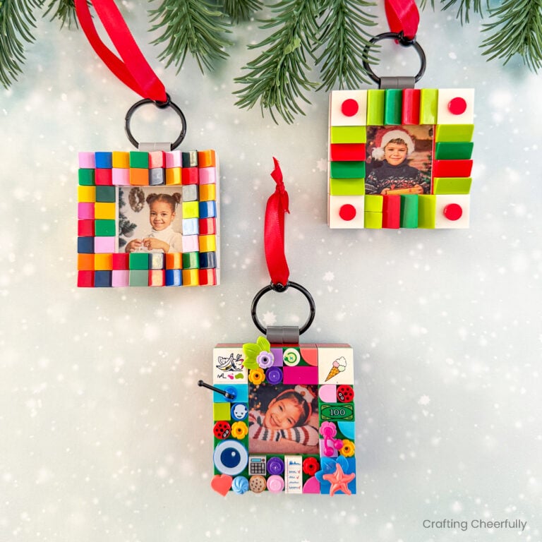 Three lego frame ornaments with children's pictures inside.