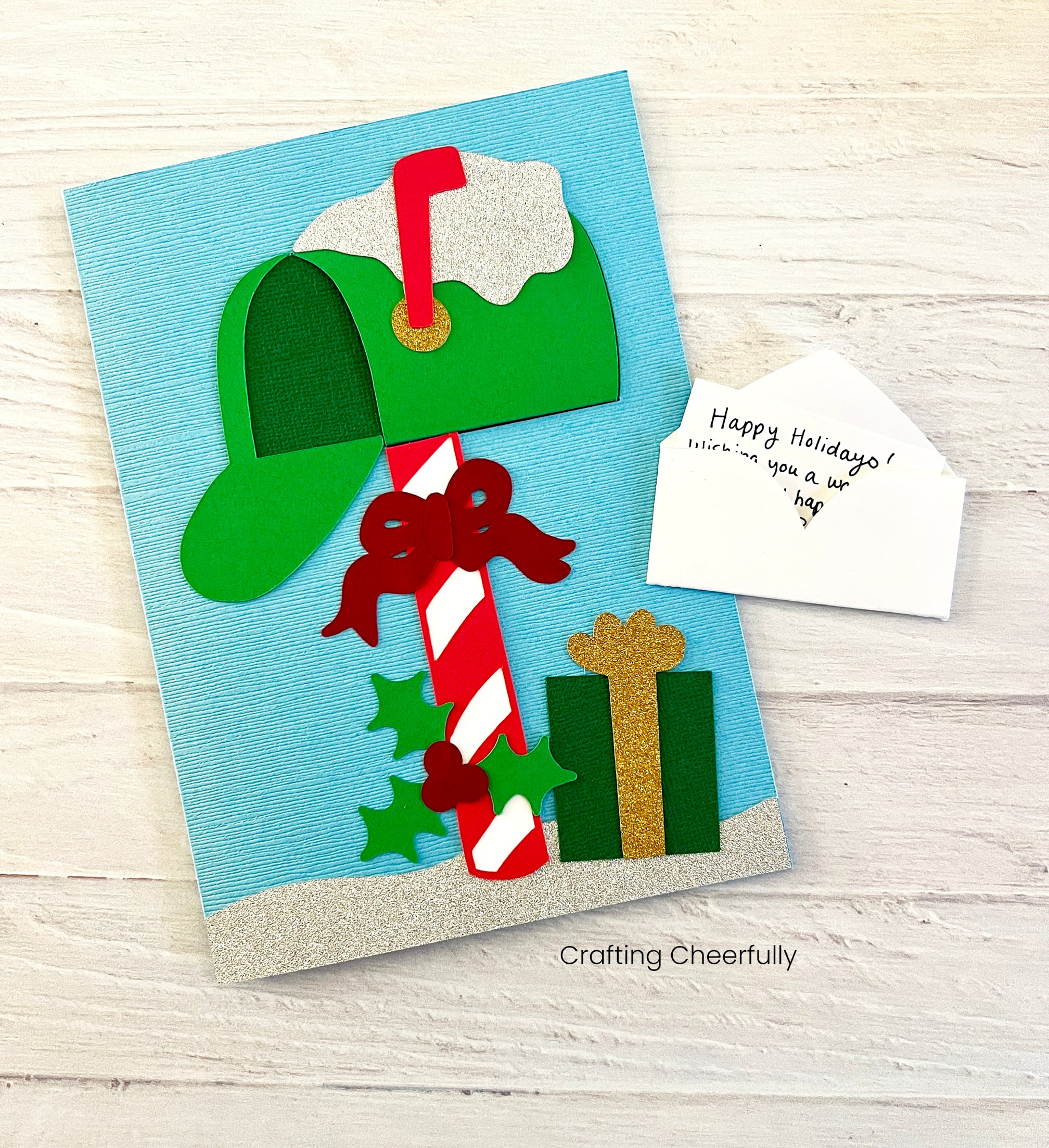 A holiday mailbox card with a cute mini letter next to it.