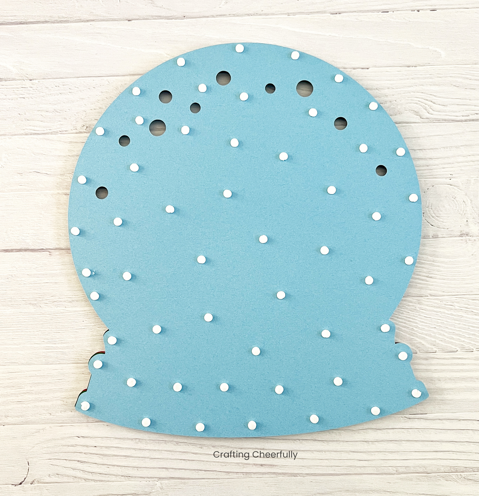 Little foam dots are added to the back of the light blue snow globe layer.
