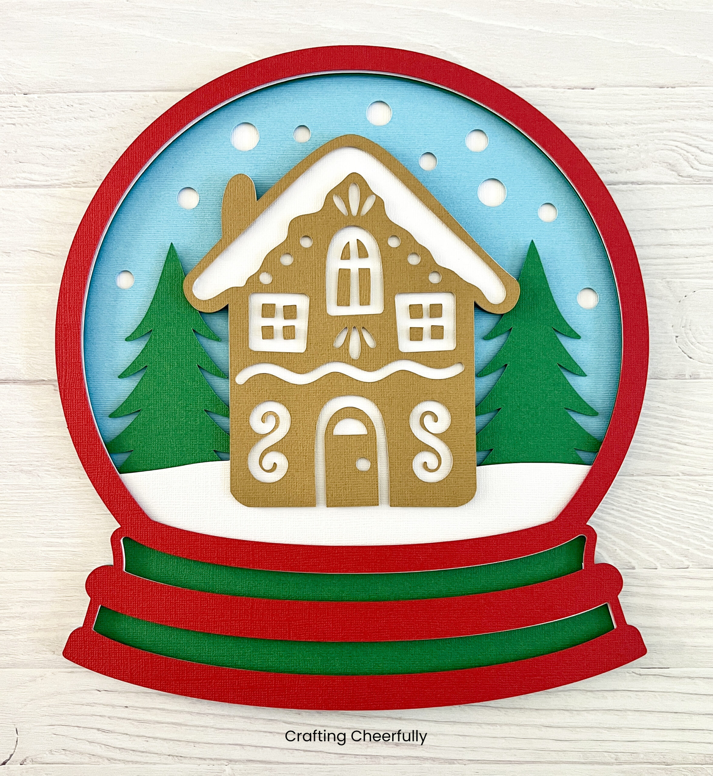 The layered paper snow globe is stacked with foam dots.