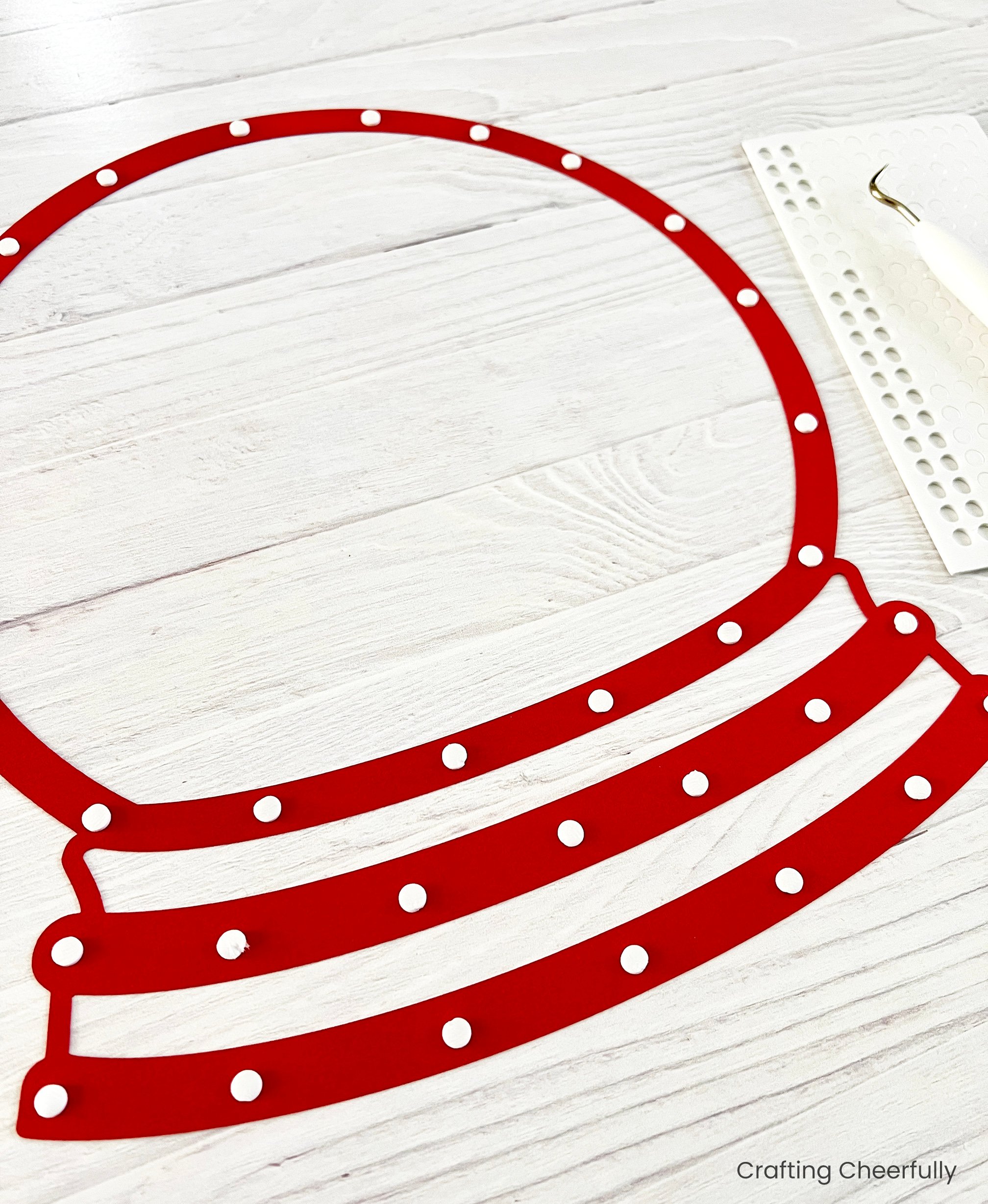 Red layer of paper with foam adhesive dots applied to the back.