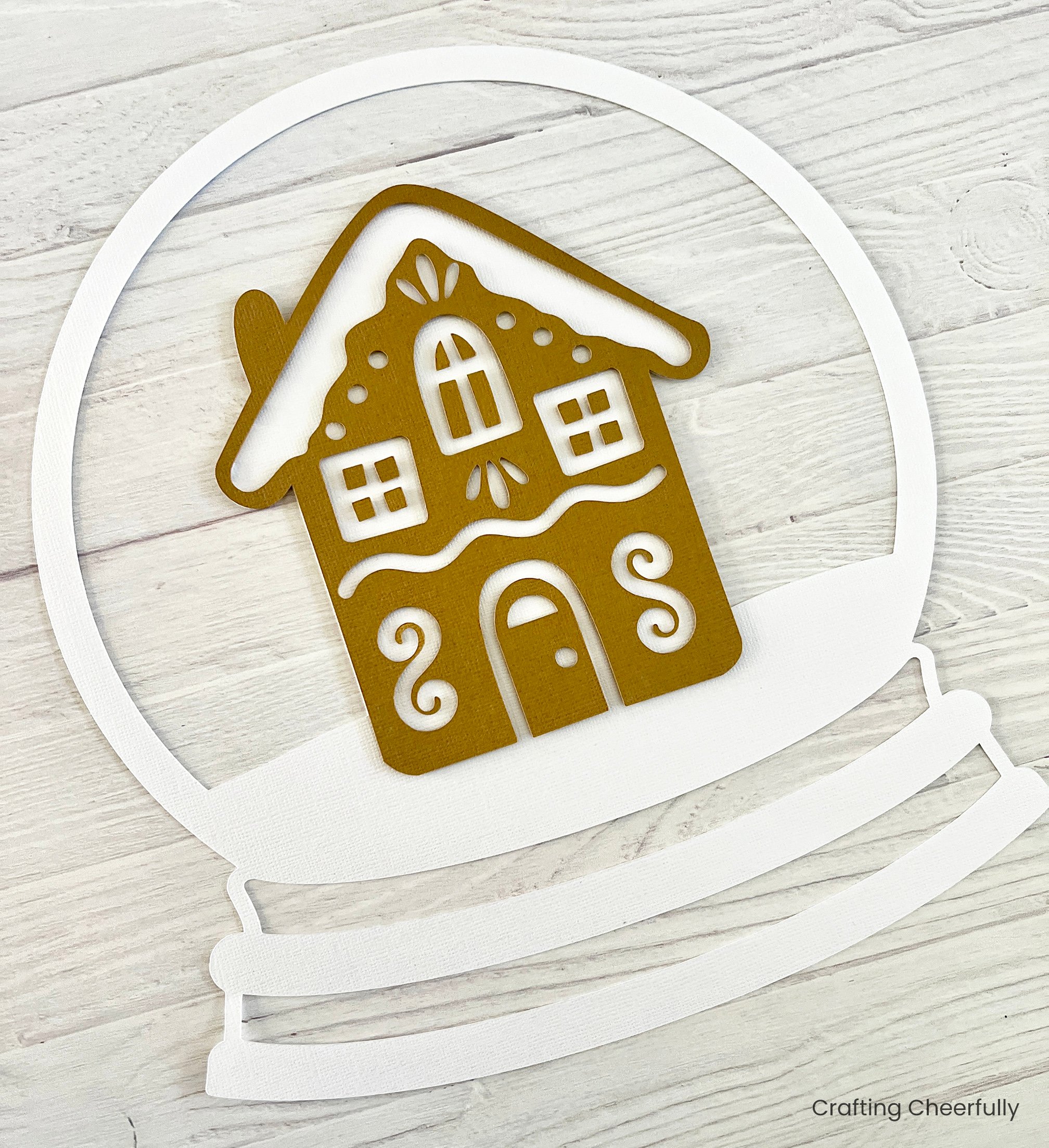 Brown gingerbread house is applied to the white snow globe layer.