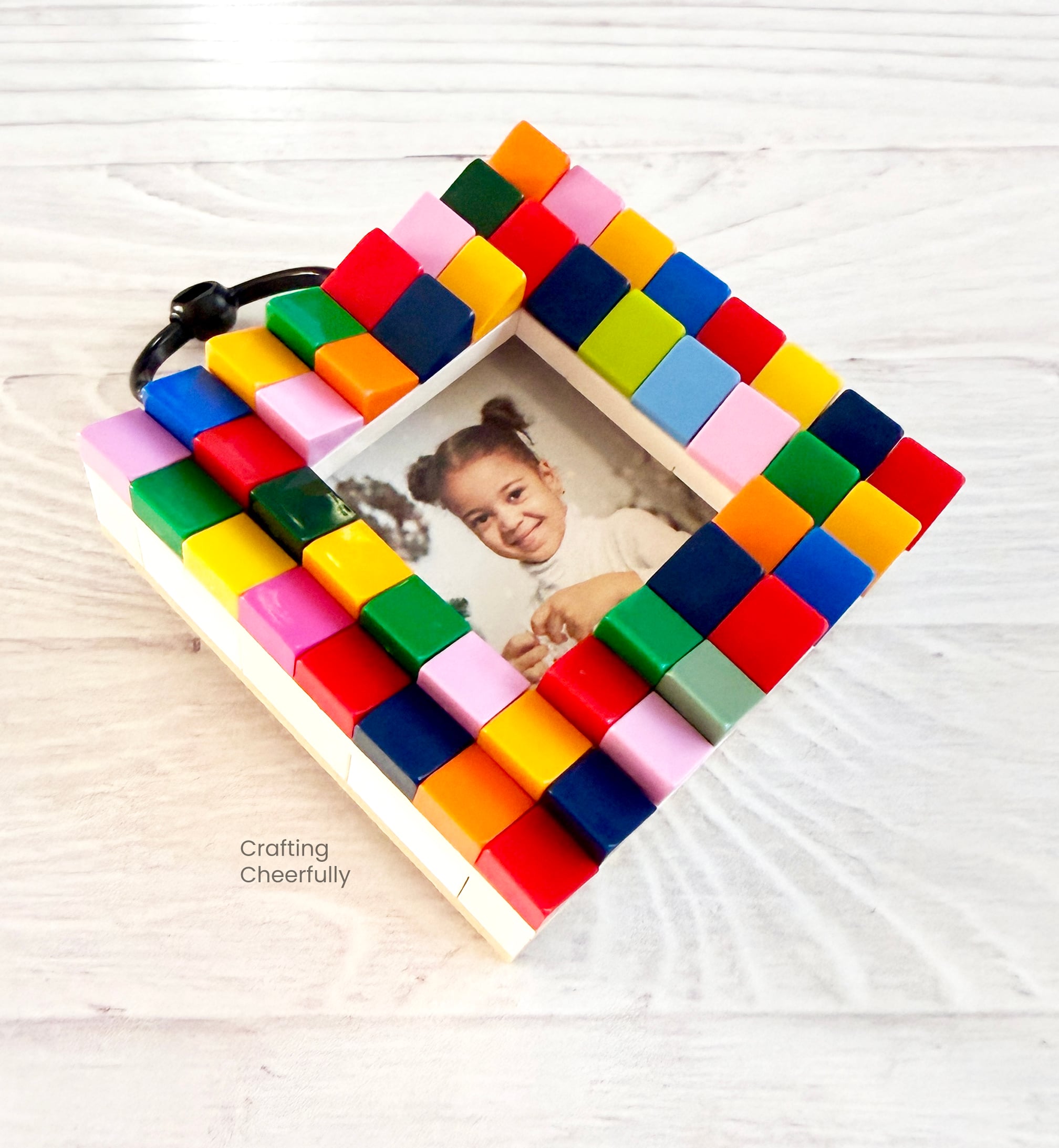 Lego frame ornament decorated with different colored cheese slope pieces.