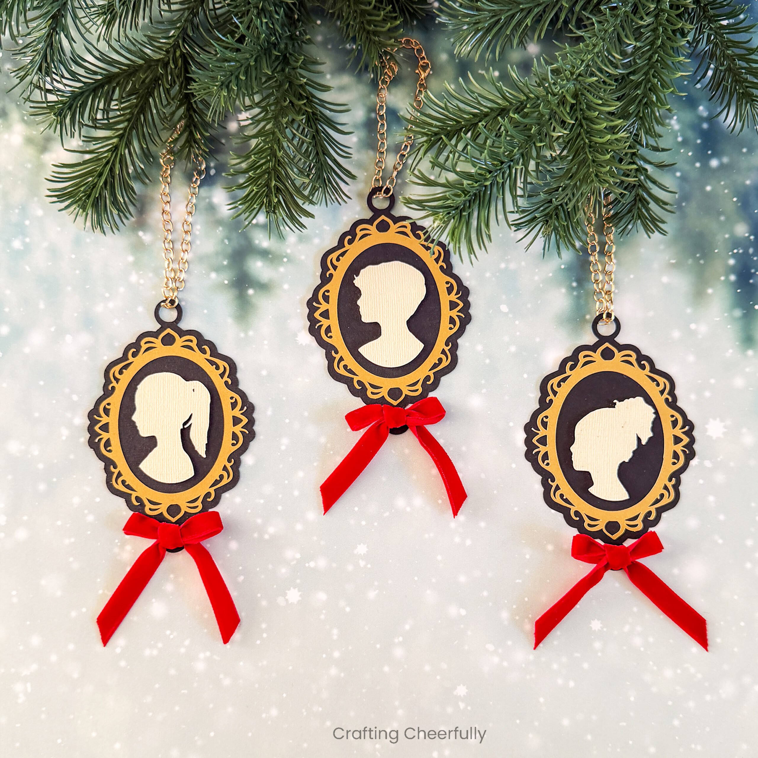 Three cameo paper silhouette ornaments in black and gold.