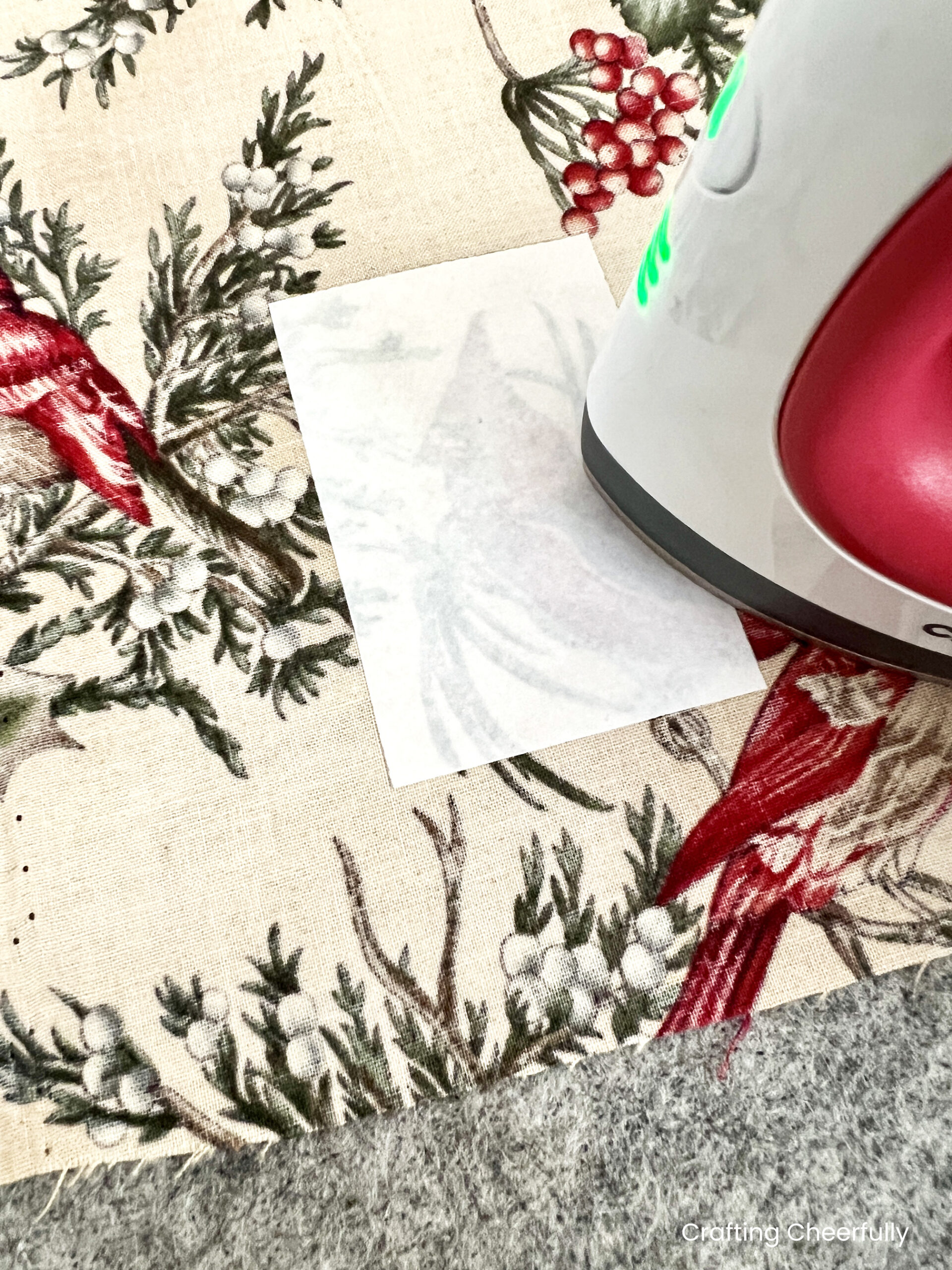 The small rectangle piece of fusible interfacing is ironed to a piece of fabric.