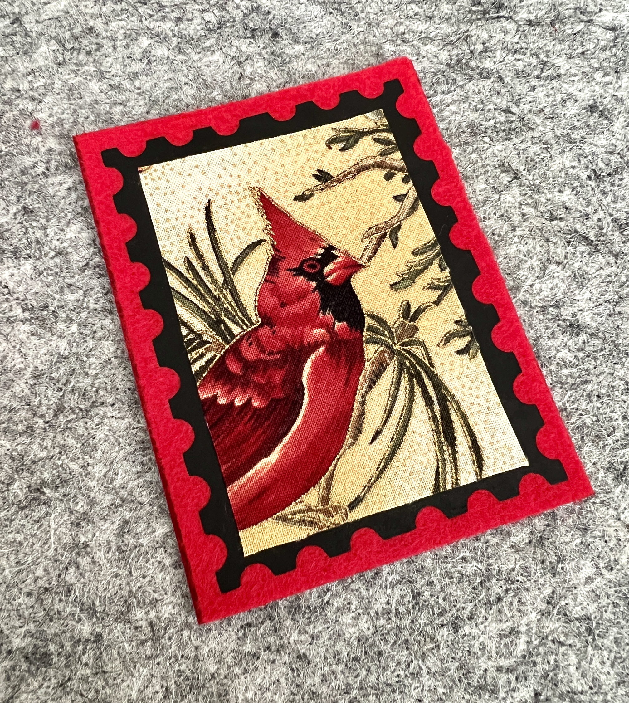 Felt and fabric postage stamp ornament.