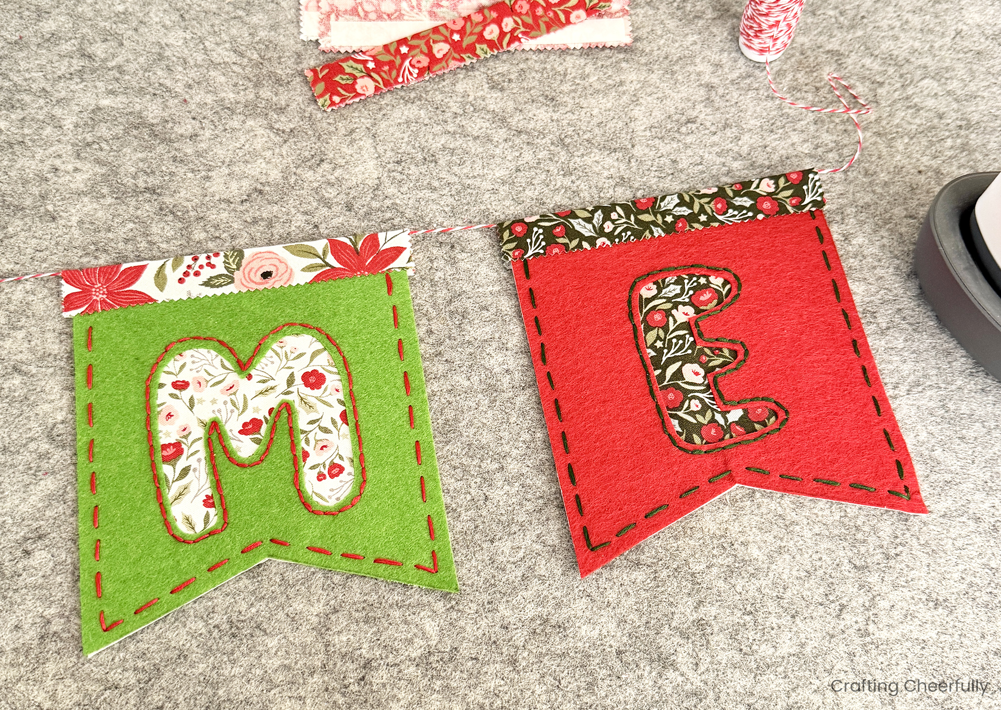 The E pennant is added to the twine next to the M pennant.