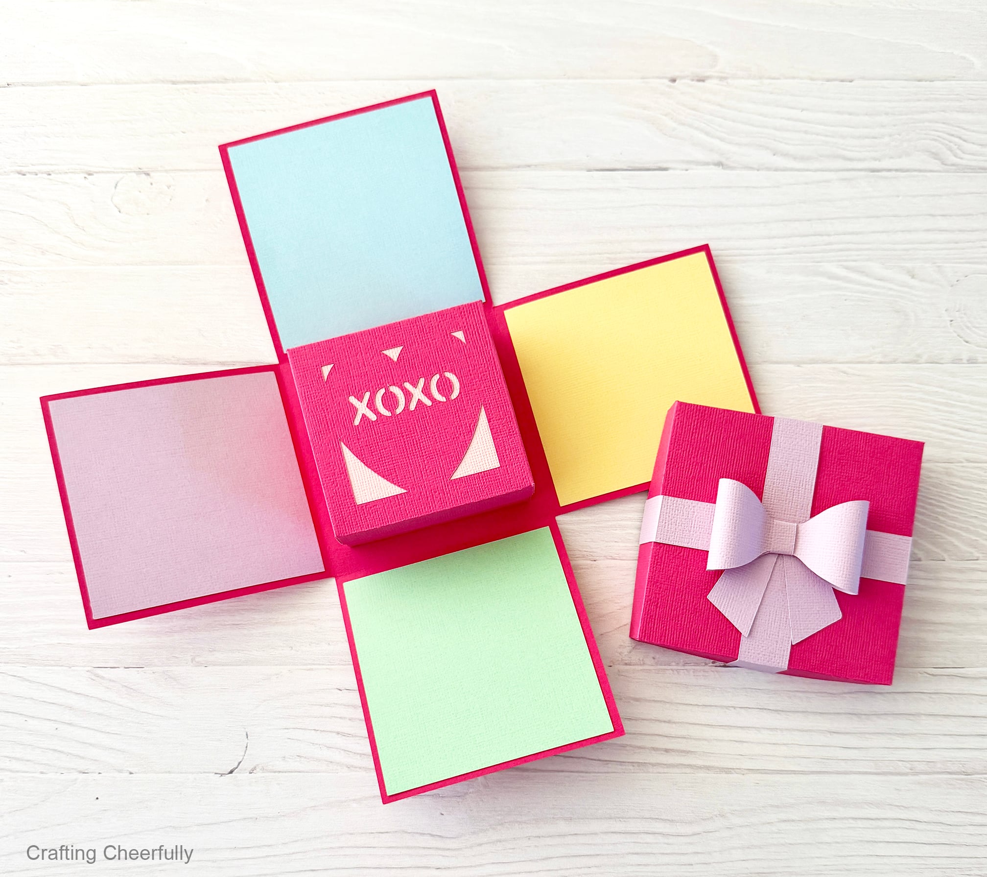 Explosion box opened to show the small heart box inside and colorful pops of color on each side flap.