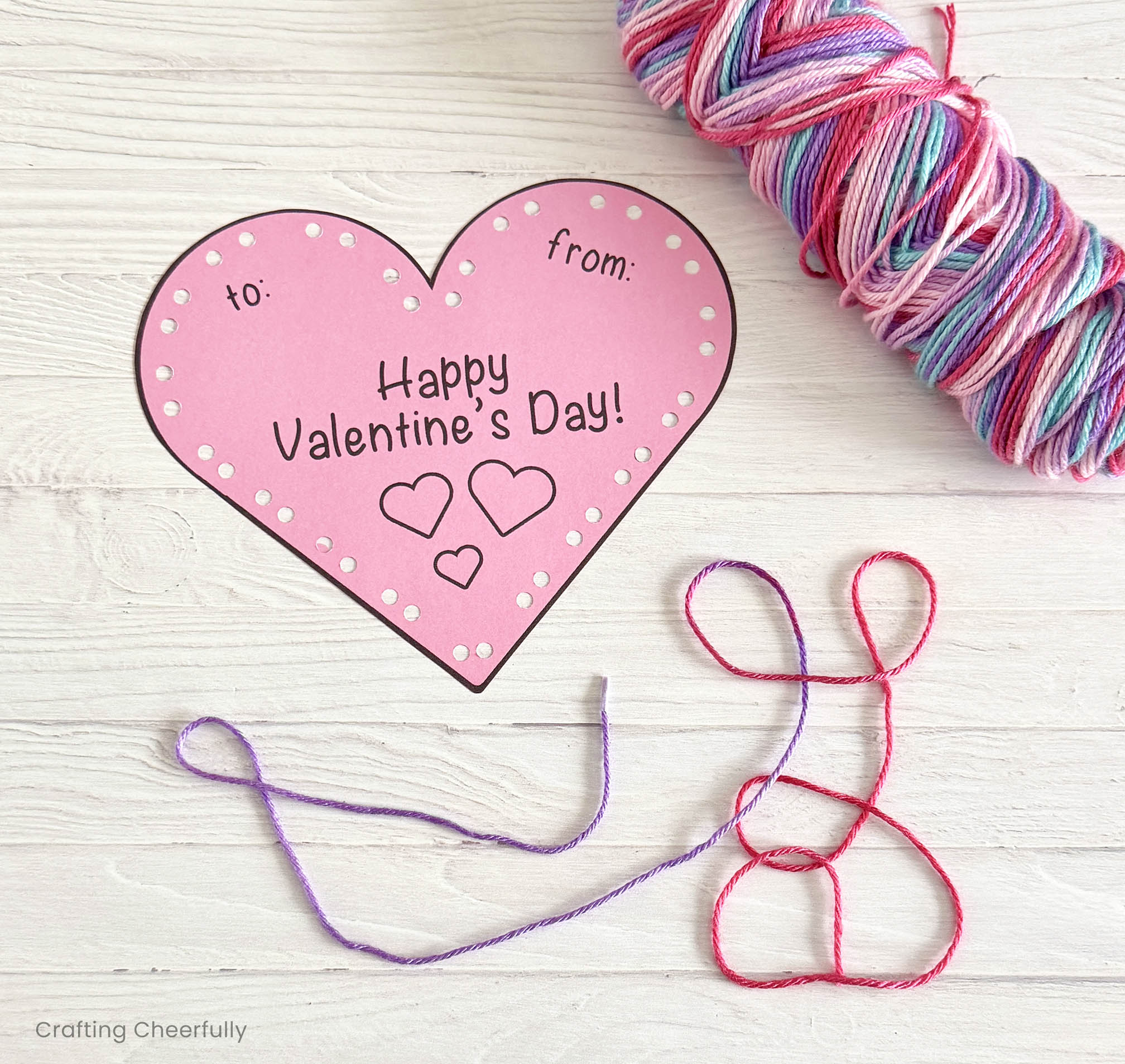 A piece of yarn is cut and the end is wrapped with clear tape.